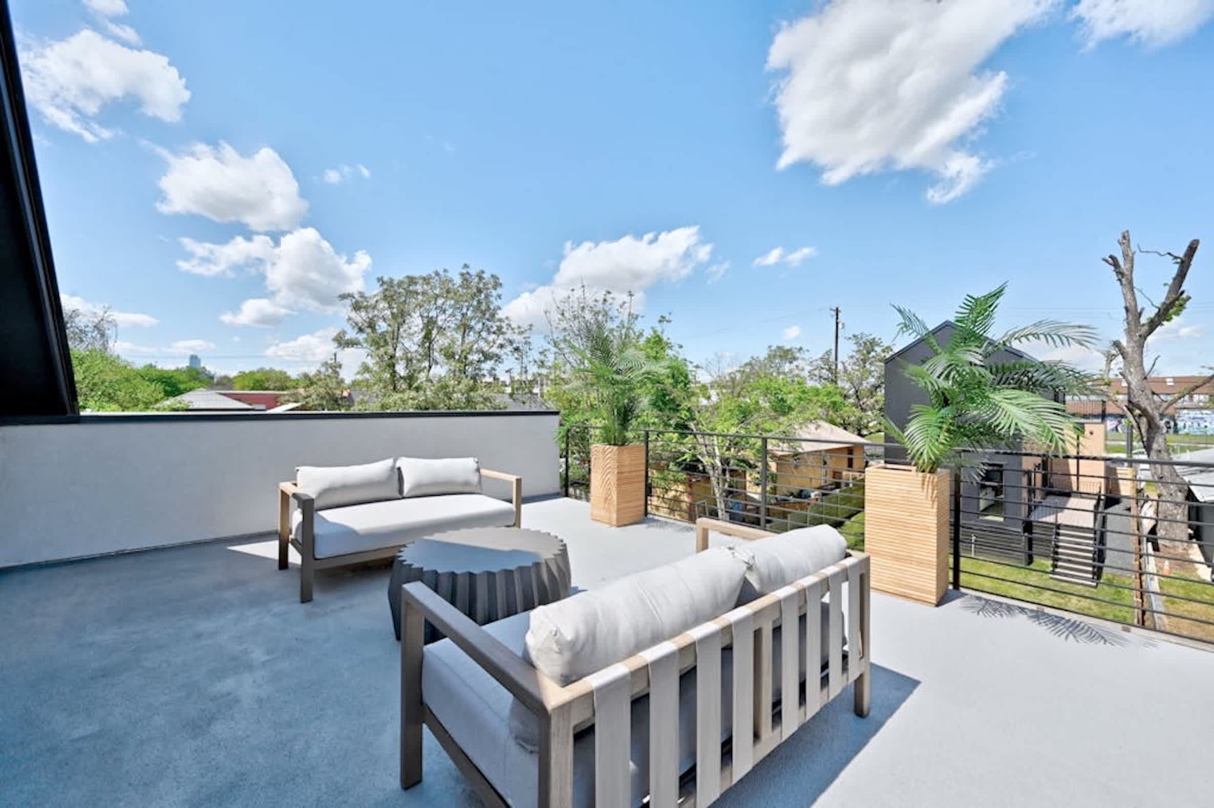 Third-floor rooftop patio w/city views—perfect for sunset chats