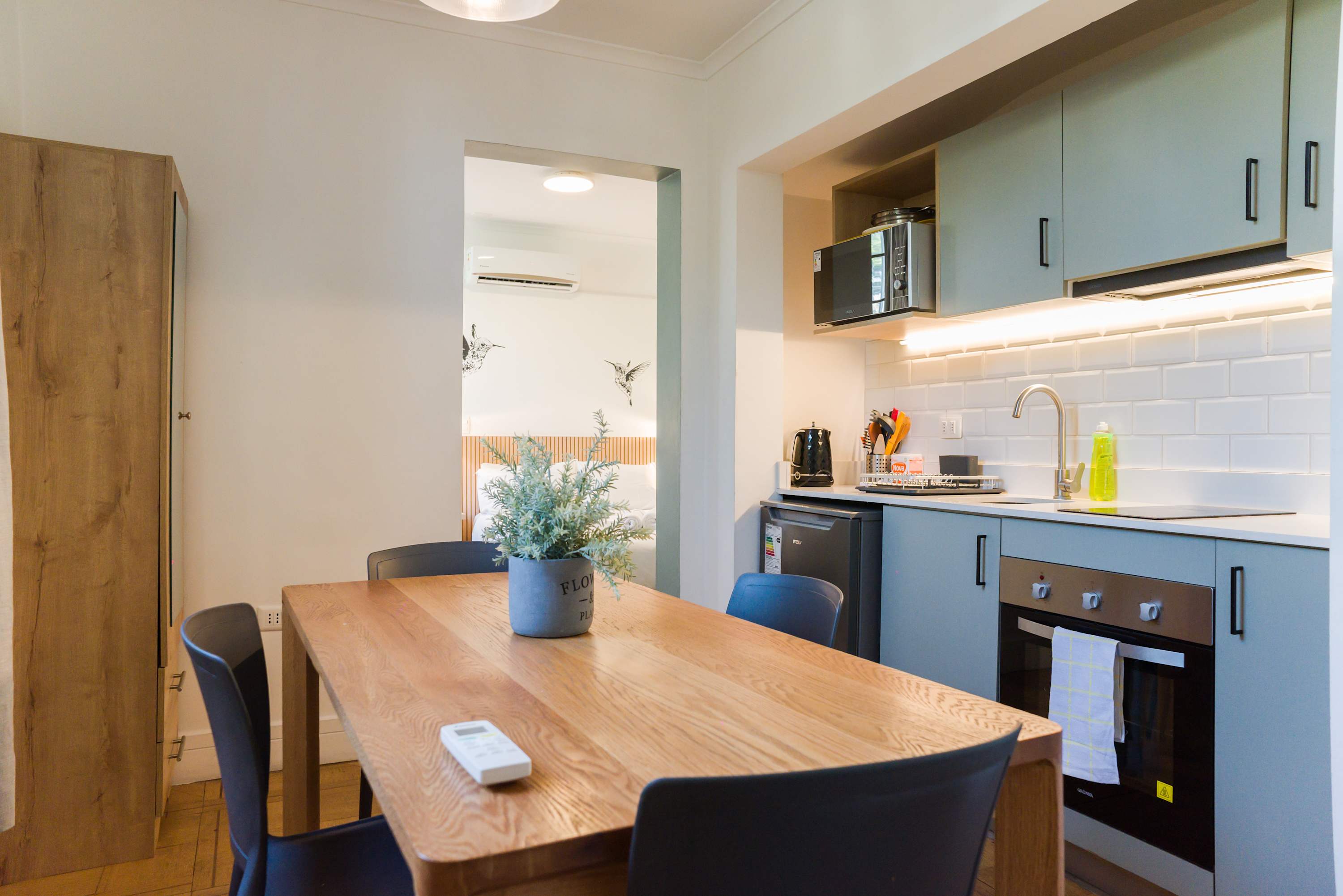 Modern kitchen with dining area, perfect for cozy meals and relaxation during your stay.
