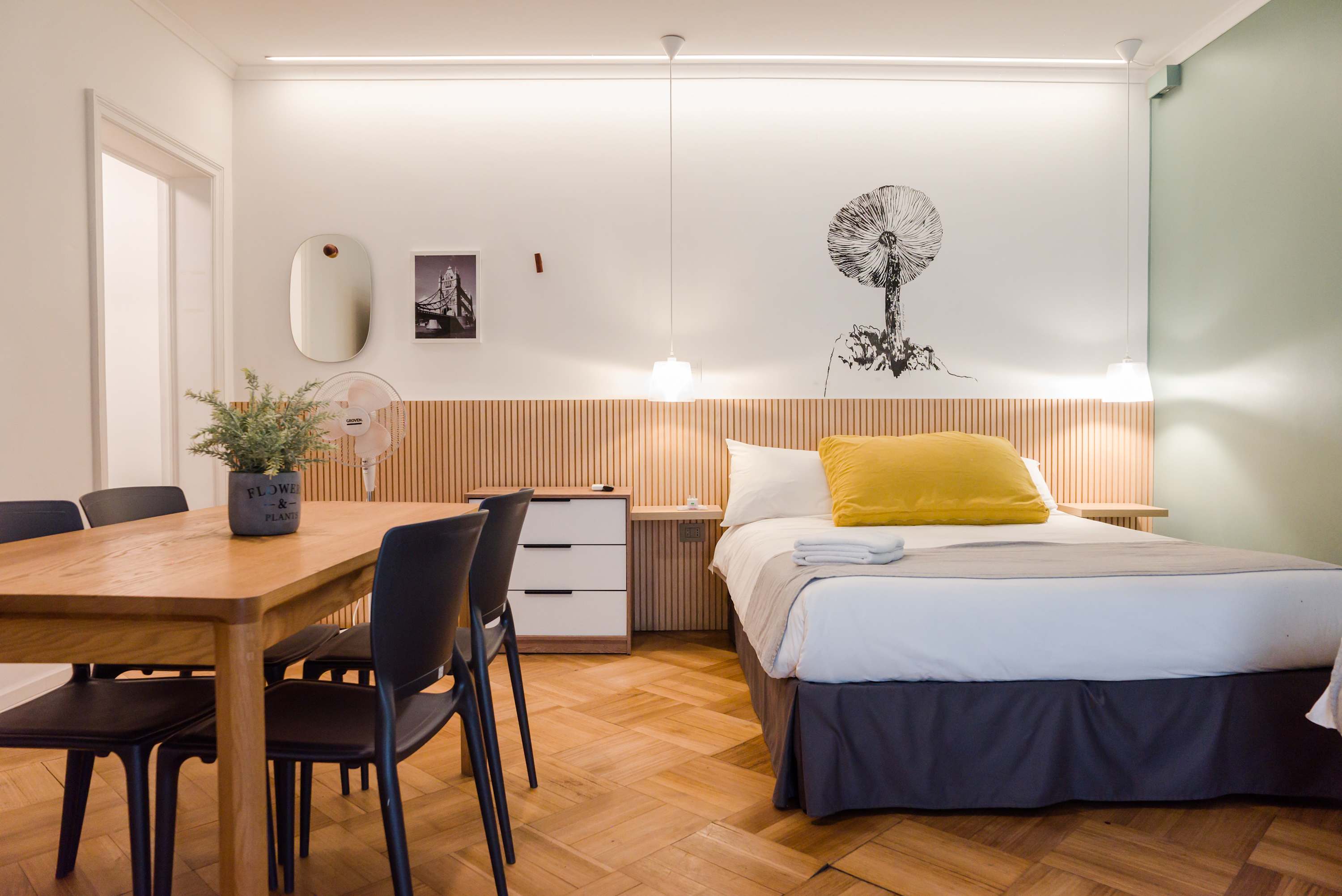 Charming studio with a cozy bed and dining area, perfect for a relaxing stay in the heart of the city.