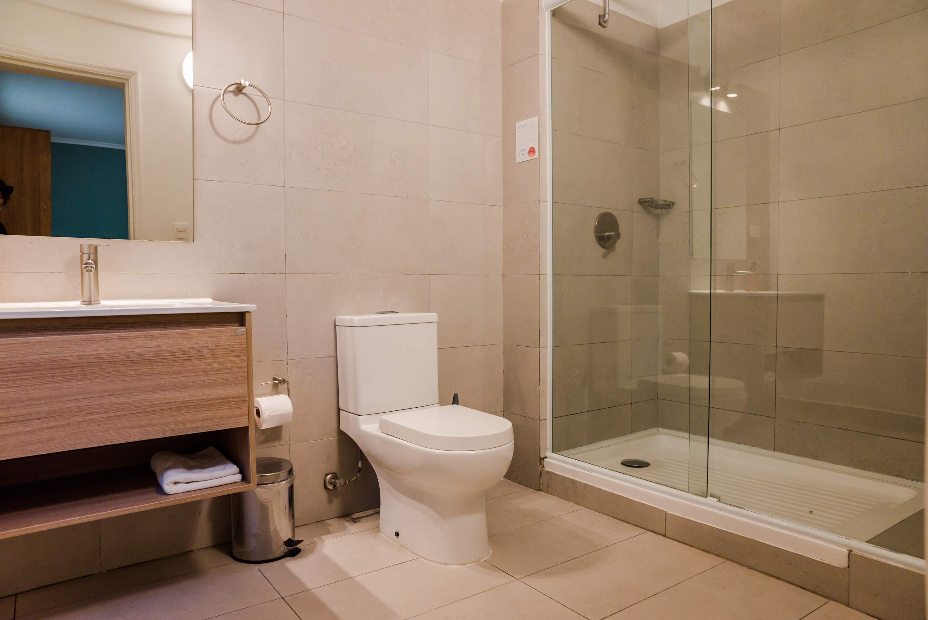 Modern bathroom with sleek glass shower and stylish vanity, offering a clean and comfortable space for your stay.