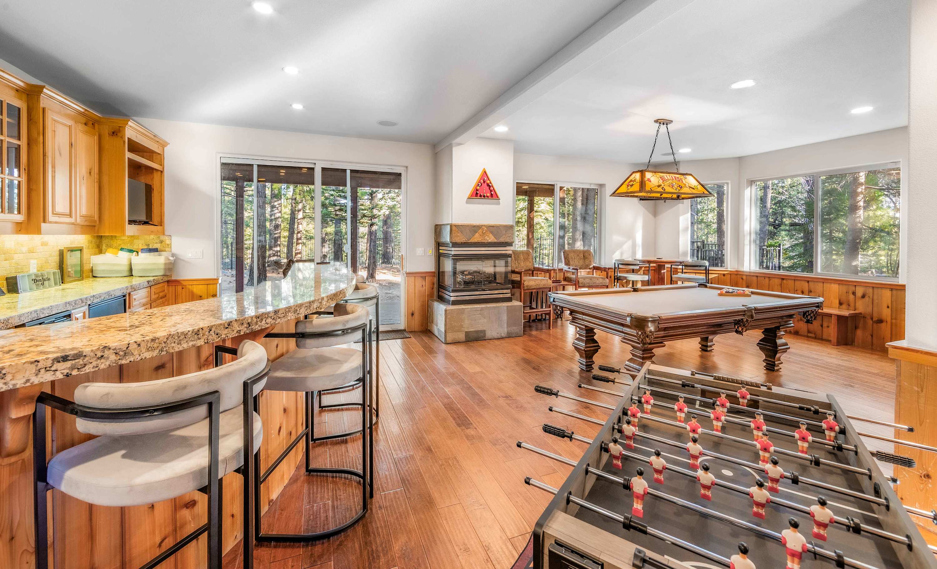 Bring the fun downstairs for some foosball, pool, or to watch the game - all complete with a wet bar, fireplace, and patio access 