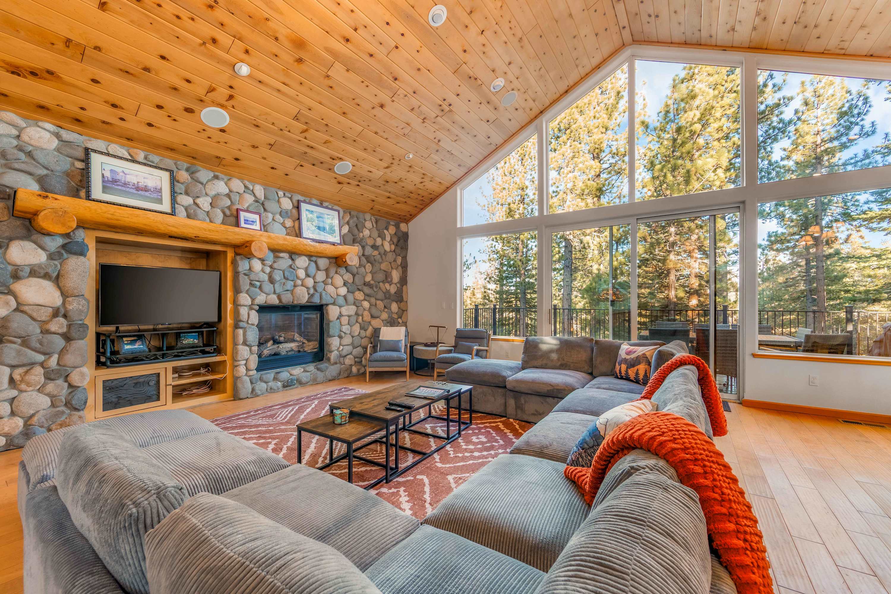 Show-stopping living room with flat screen, fireplace, huge wrap-around sectional, and deck access 