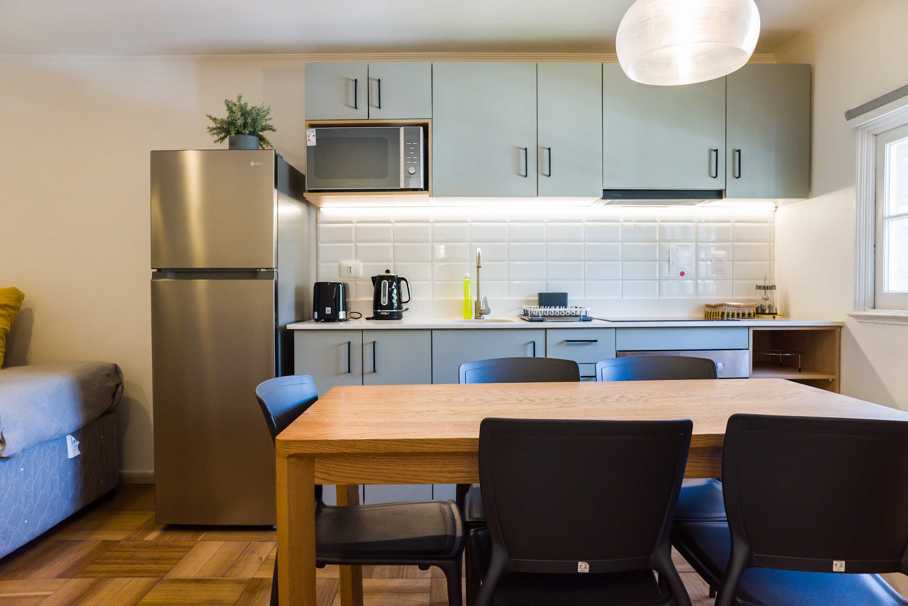 Modern kitchen with sleek appliances and a cozy dining area, perfect for enjoying meals together.
