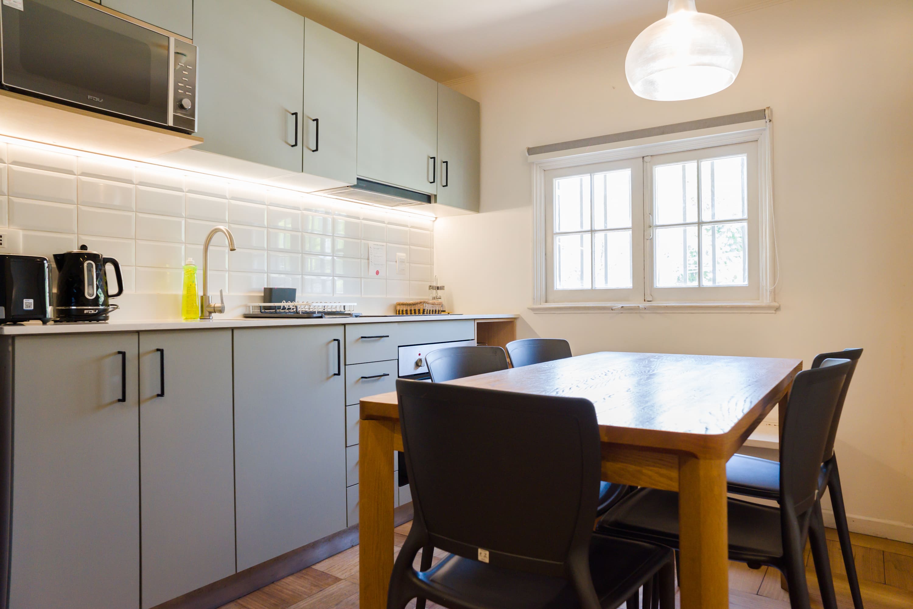 Bright and modern kitchen with ample seating, perfect for family meals or entertaining guests.