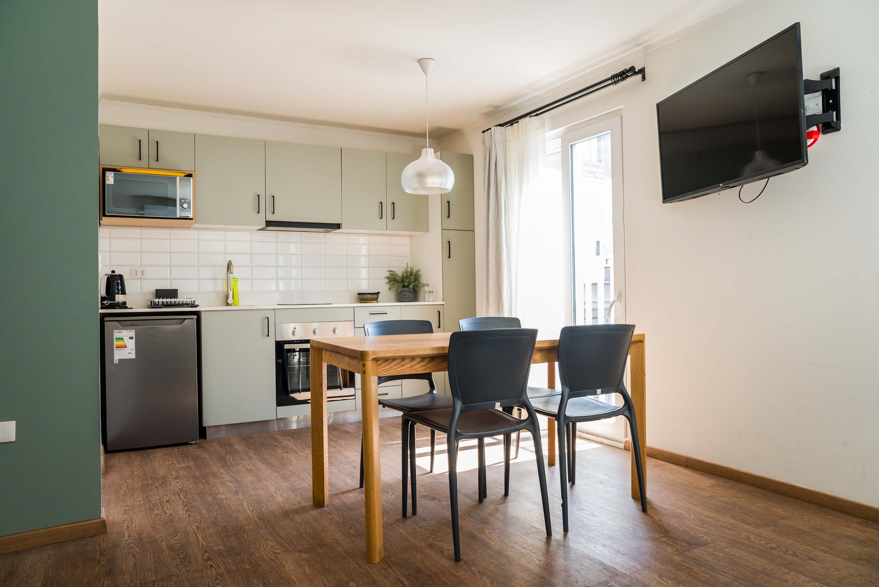 Bright and modern kitchen with dining area, perfect for cozy meals and relaxation.