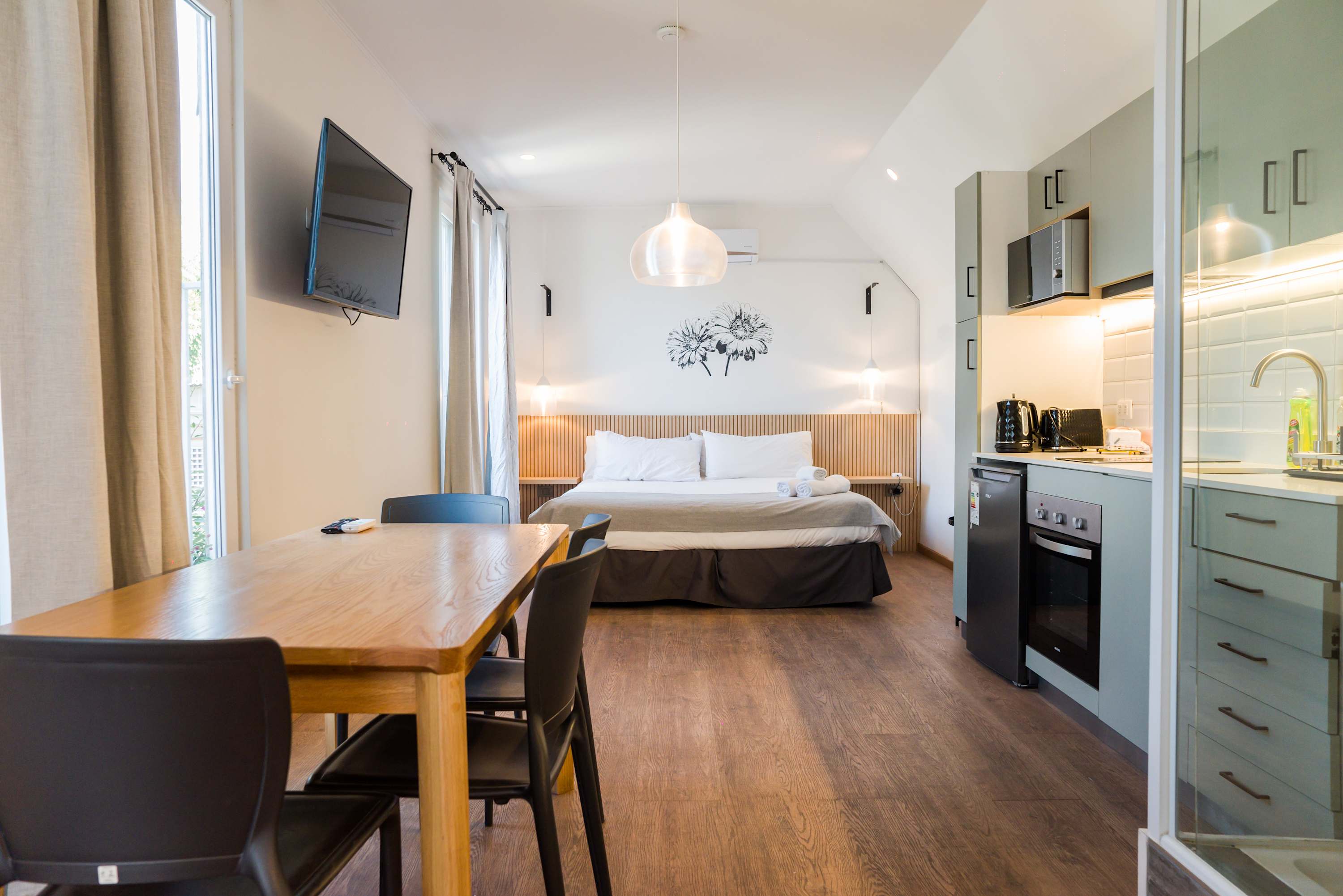 Cozy and modern studio with a fully equipped kitchen, dining area, and comfortable sleeping space. Perfect for a relaxing stay.