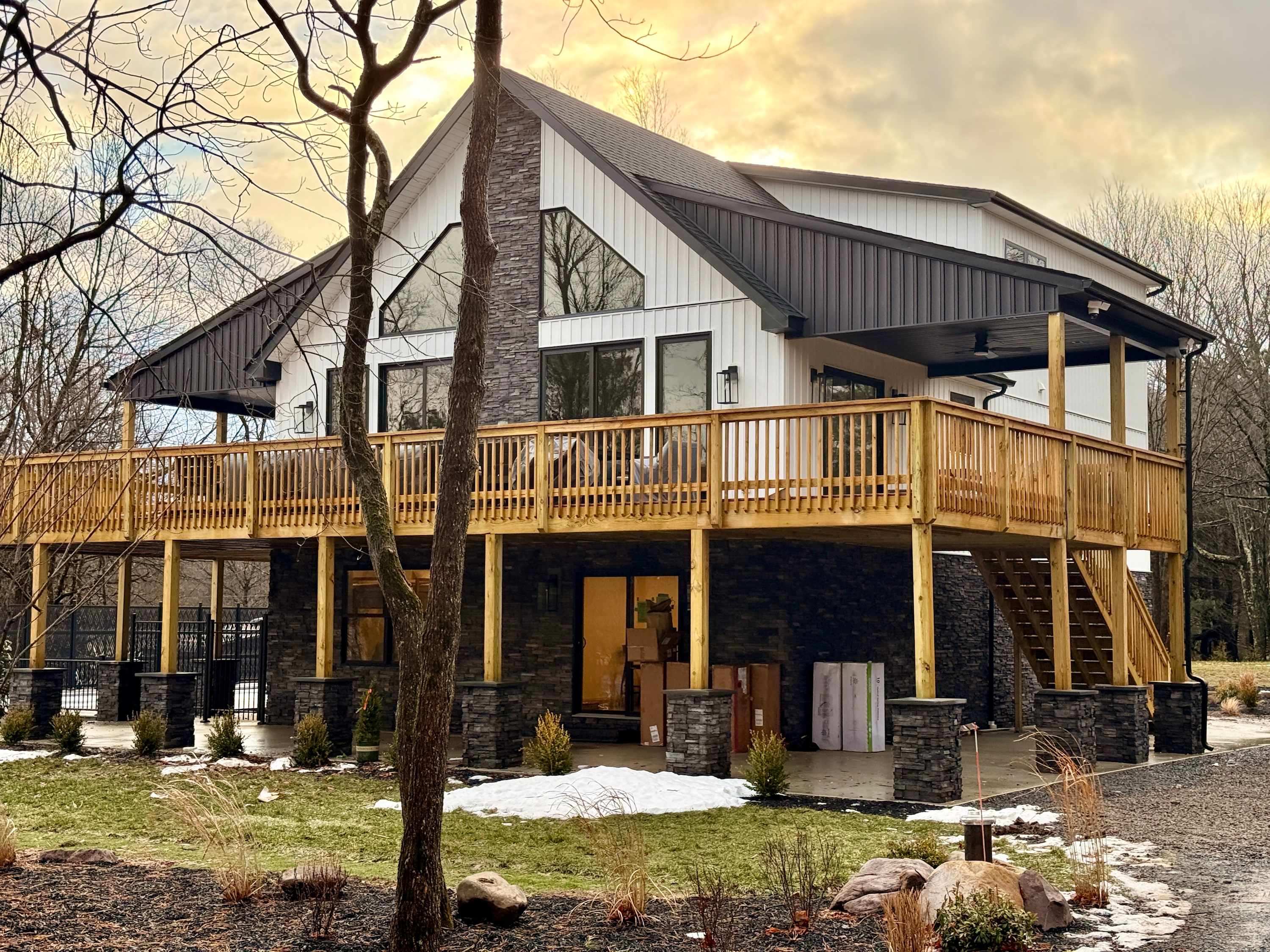 Welcome to your mountain retreat with a sprawling wraparound deck nestled among the trees