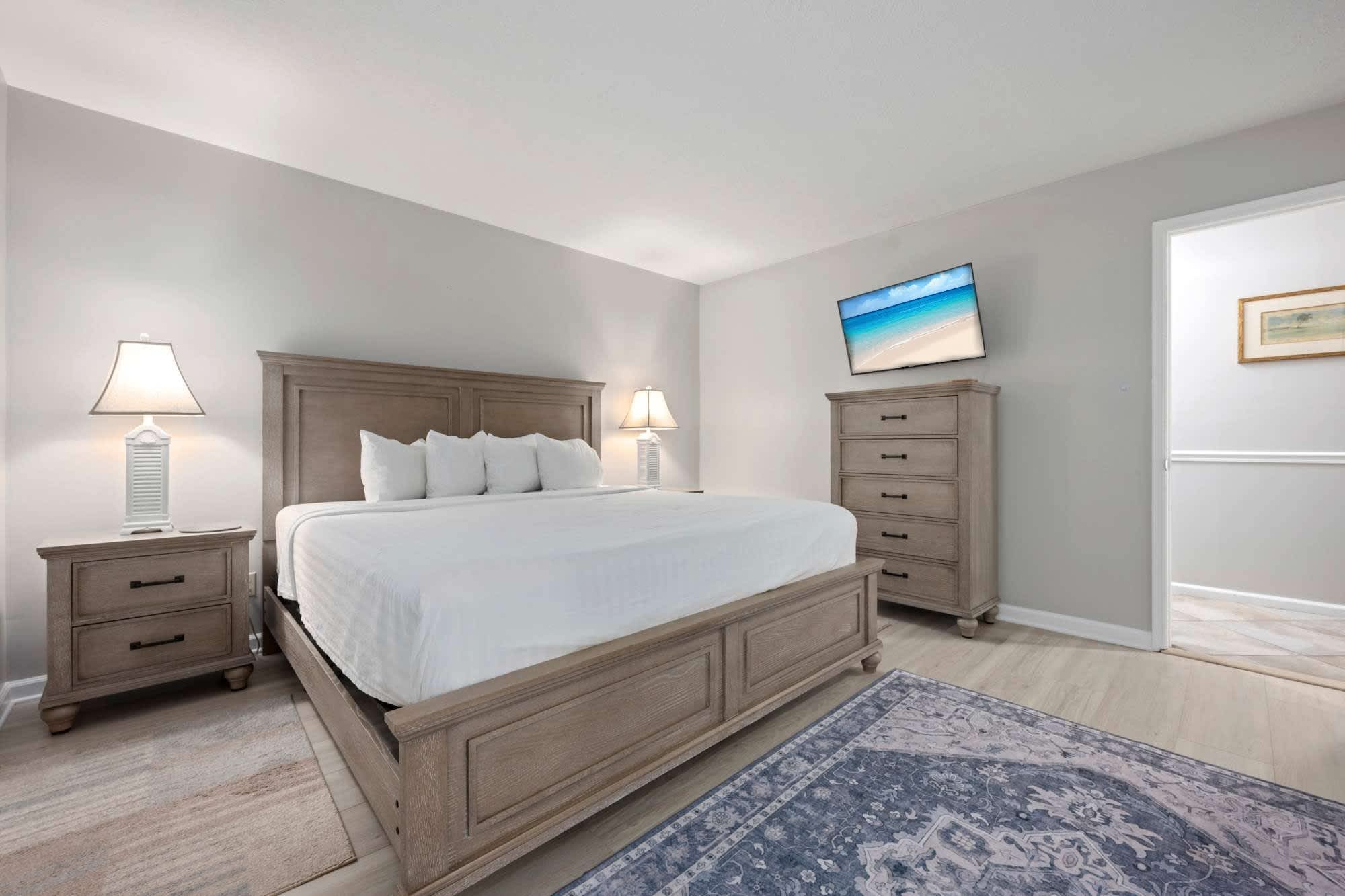 Bedroom 1 with king bed, TV, and shared ensuite (1st floor)