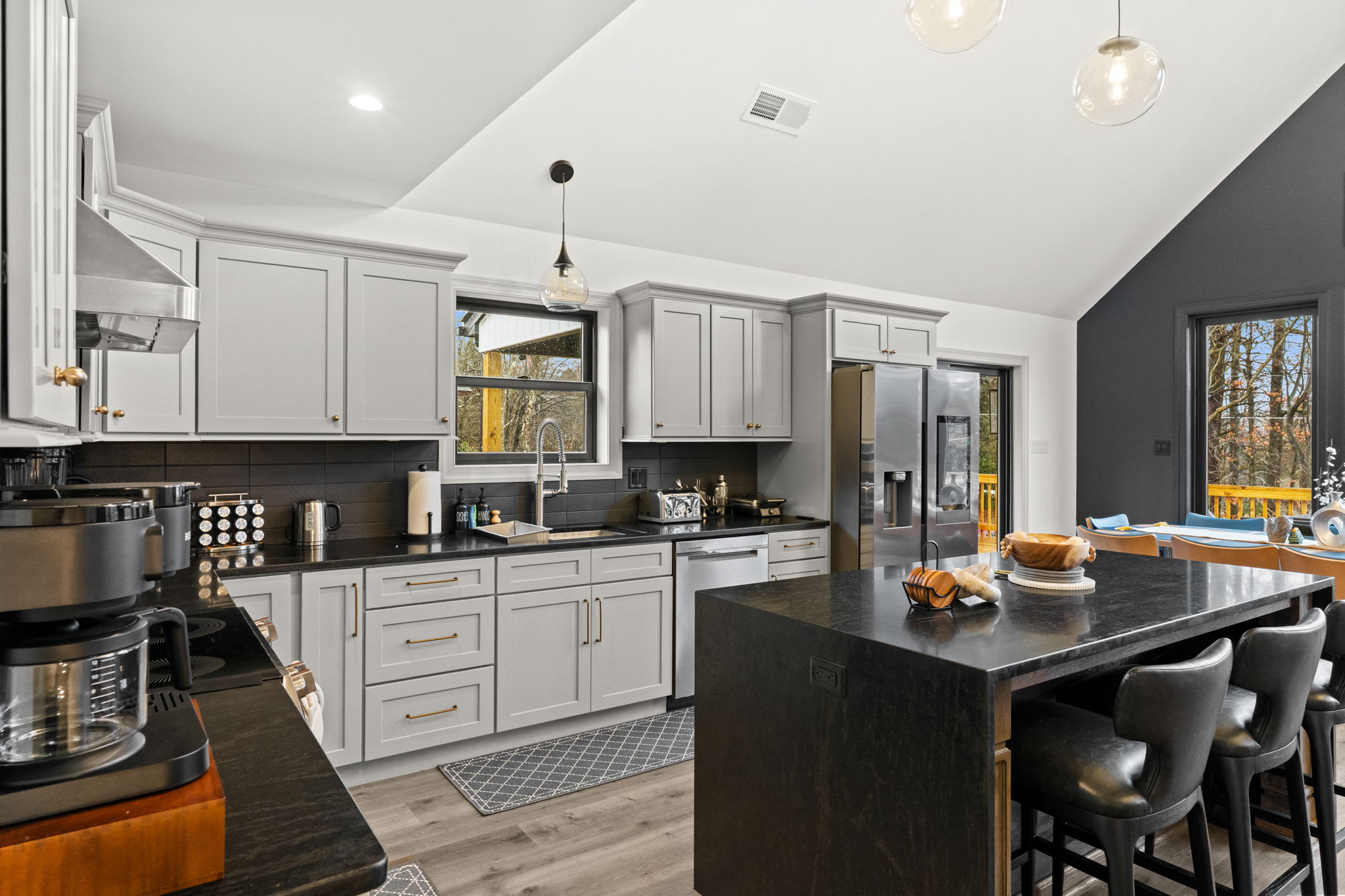 Cook while chatting with guests at the kitchen island and dining table