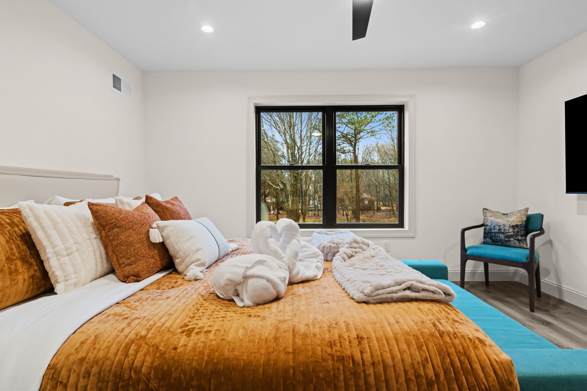 Sleep soundly in this cozy bedroom with warm rust tones and a reading corner