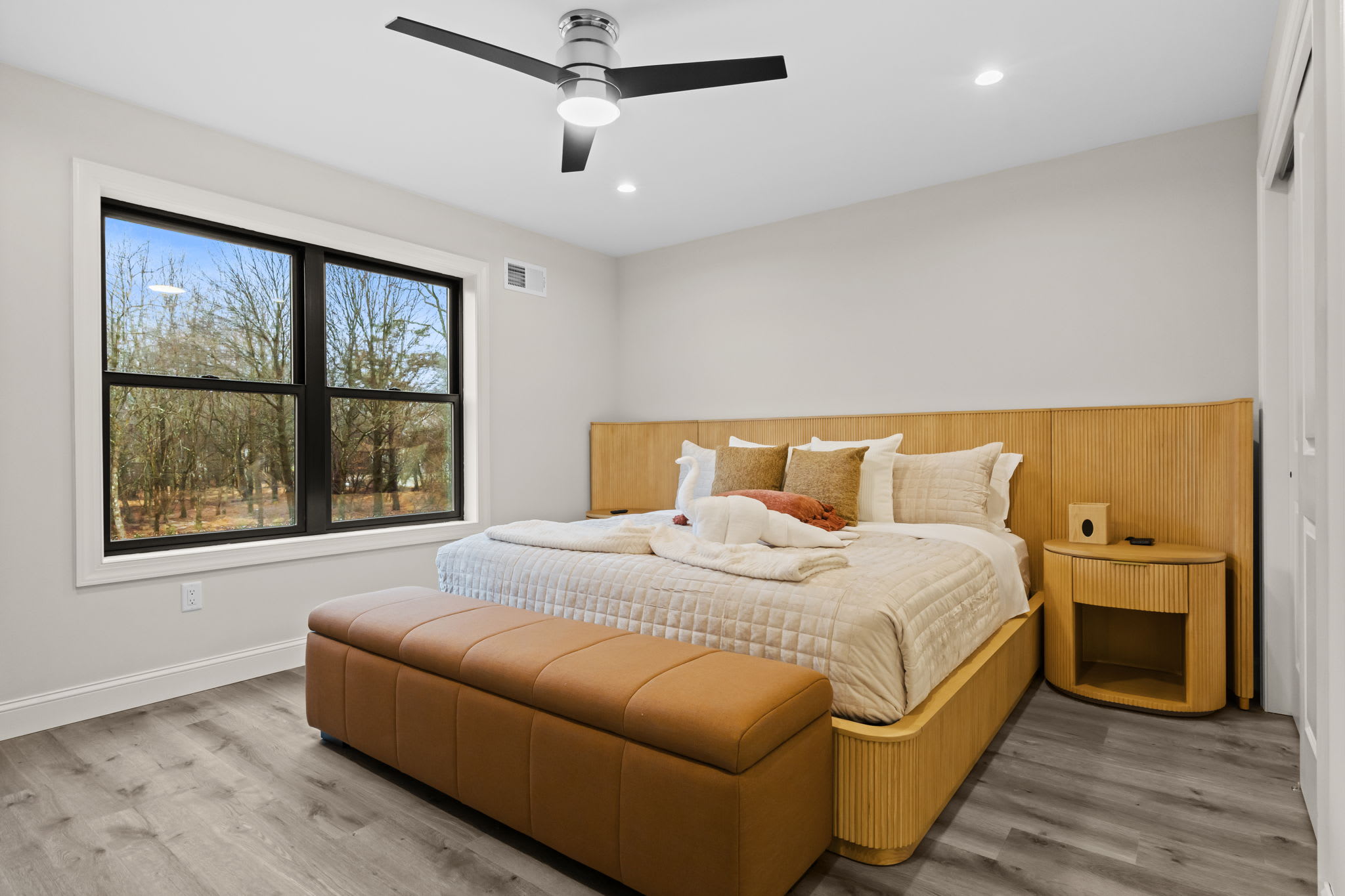 Wake up to natural light and tree views in this golden-hued bedroom retreat
