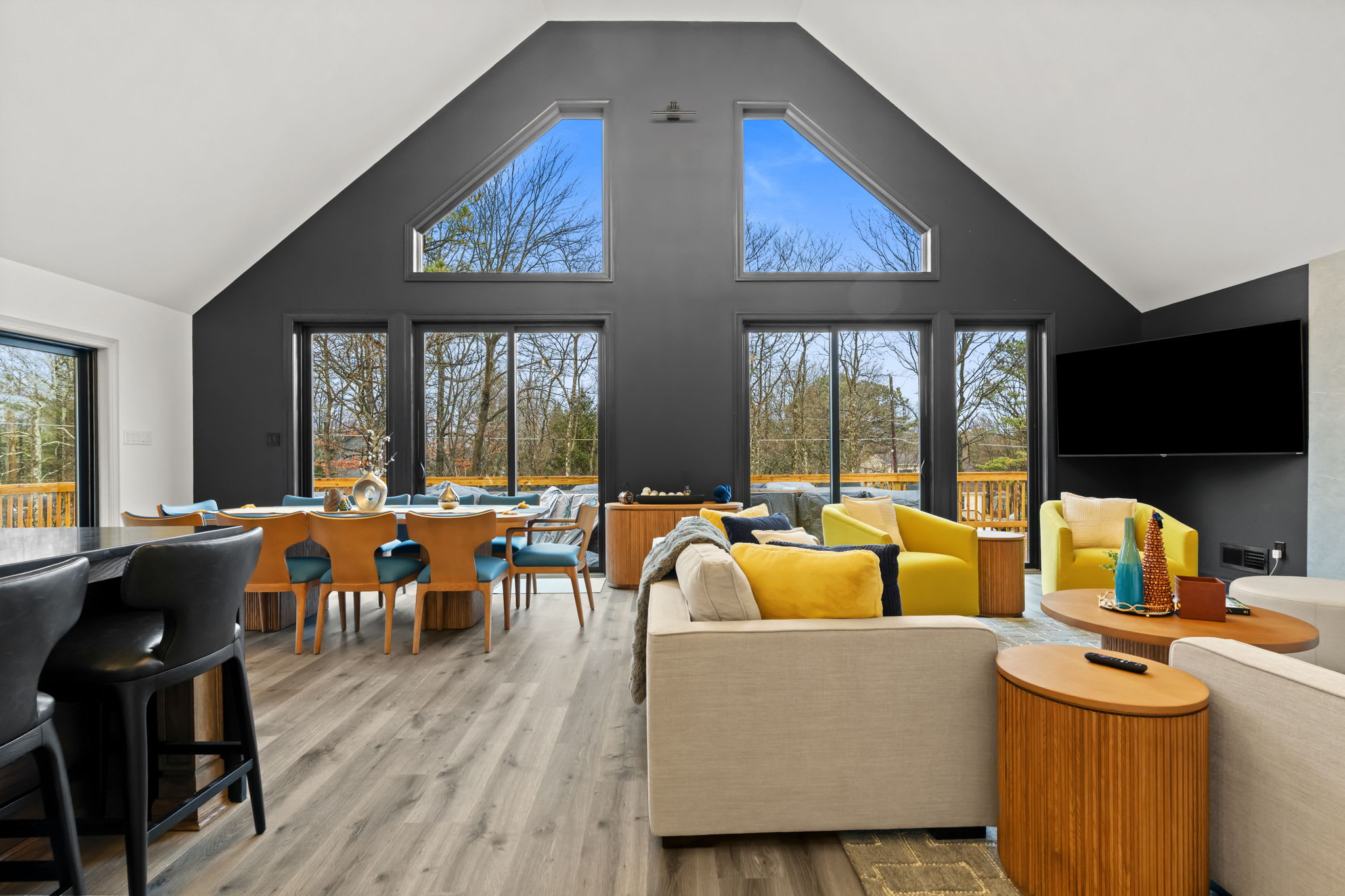 Gather around the dining table with blue velvet seating and views of the surrounding trees