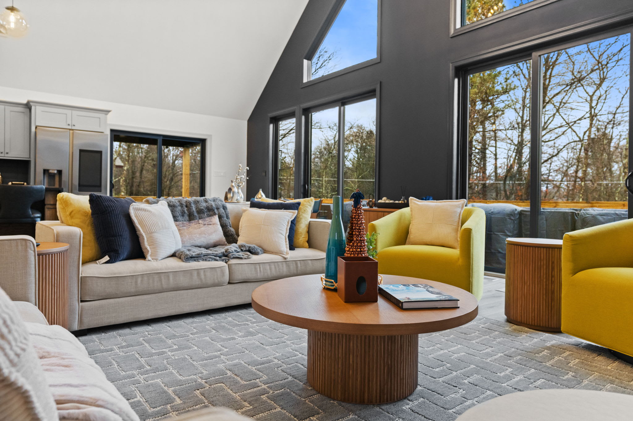 Sink into the colorful sectional seating surrounded by natural light and wooded views
