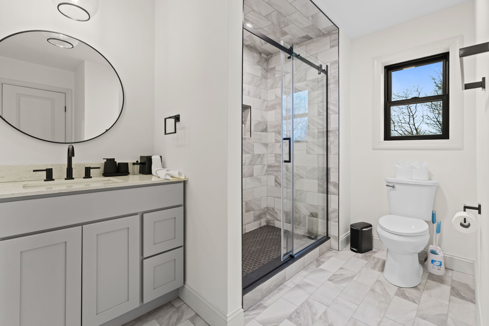 Start your day at the double vanity with elegant round mirrors and ample counter space