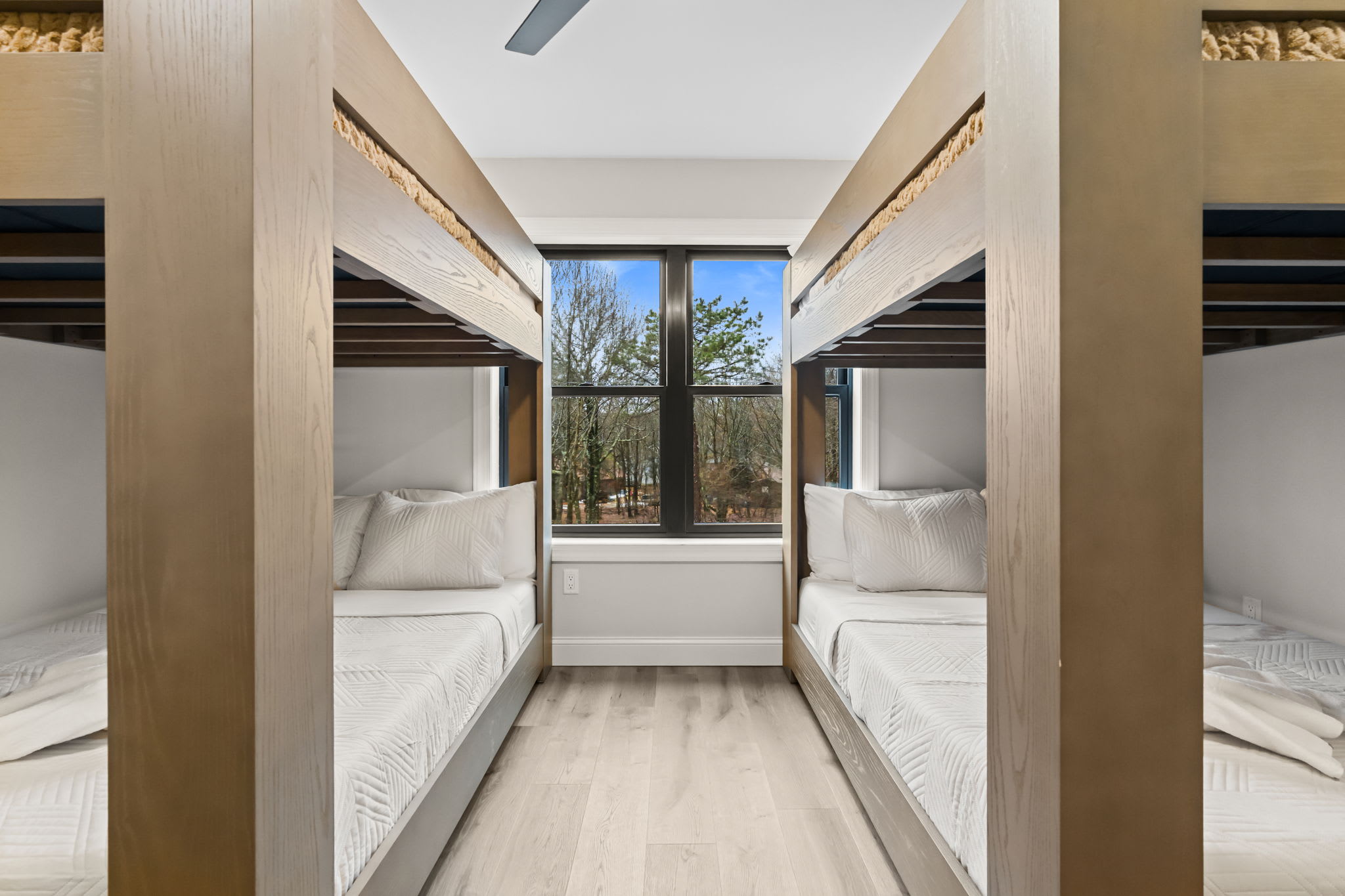 Settle into the charming wooden bunks with forest views framed by the window