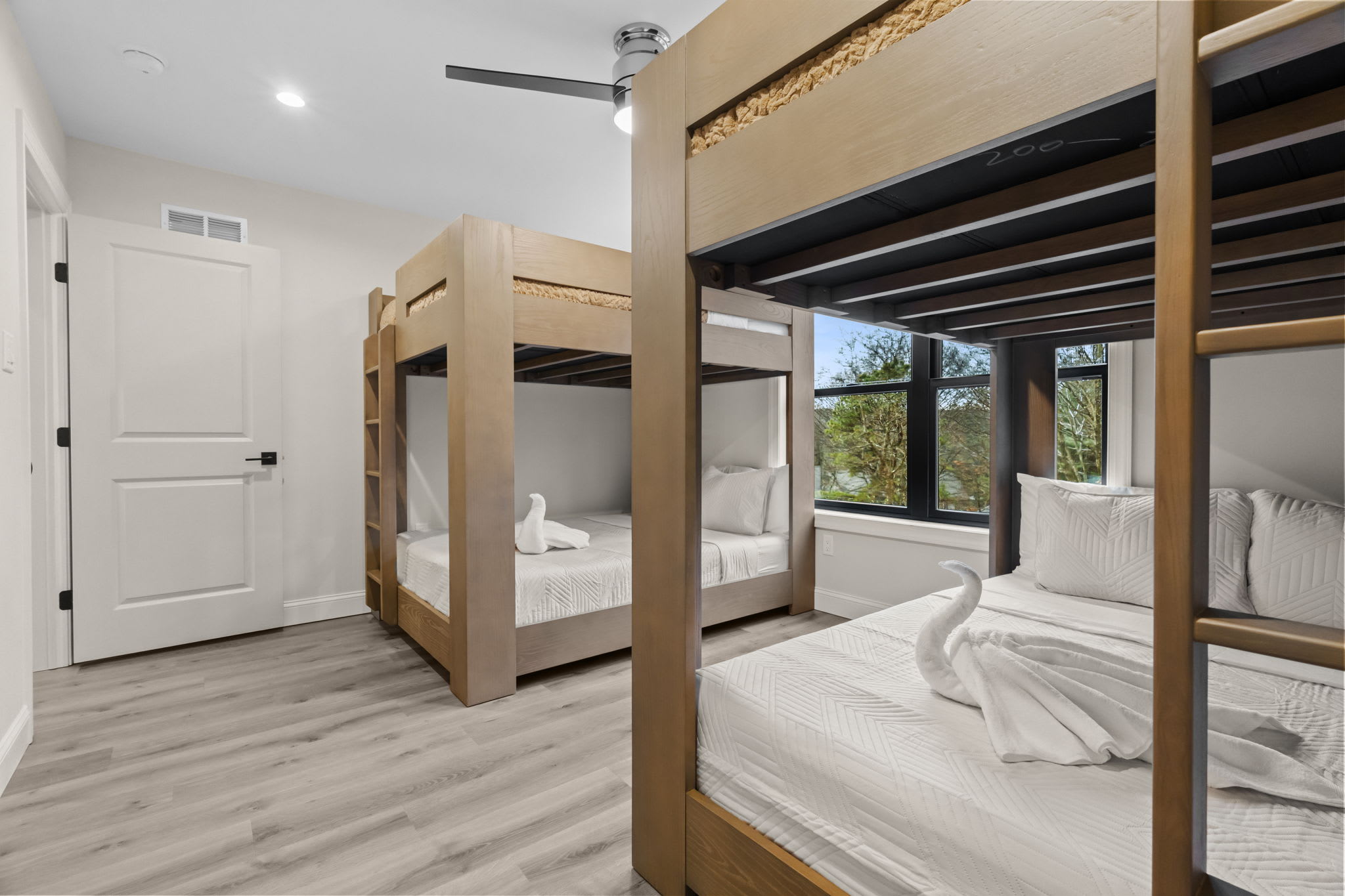 Towel art awaits in the spacious bunk room perfect for friends and family sleepovers