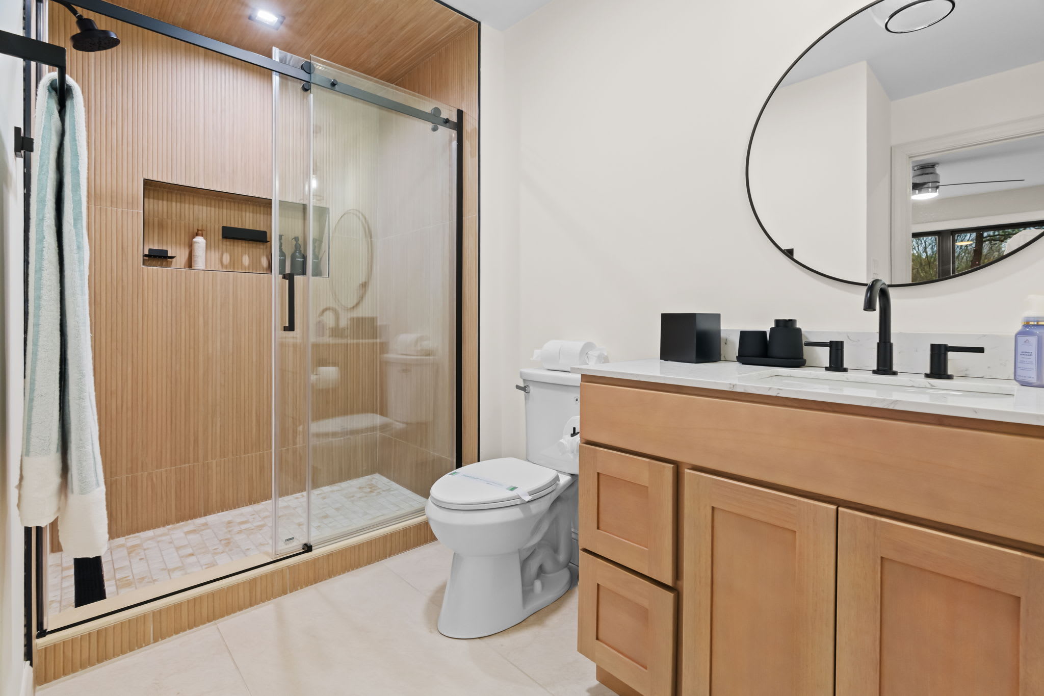 Freshen up in the well-appointed bathroom with modern gray vanity and large mirror