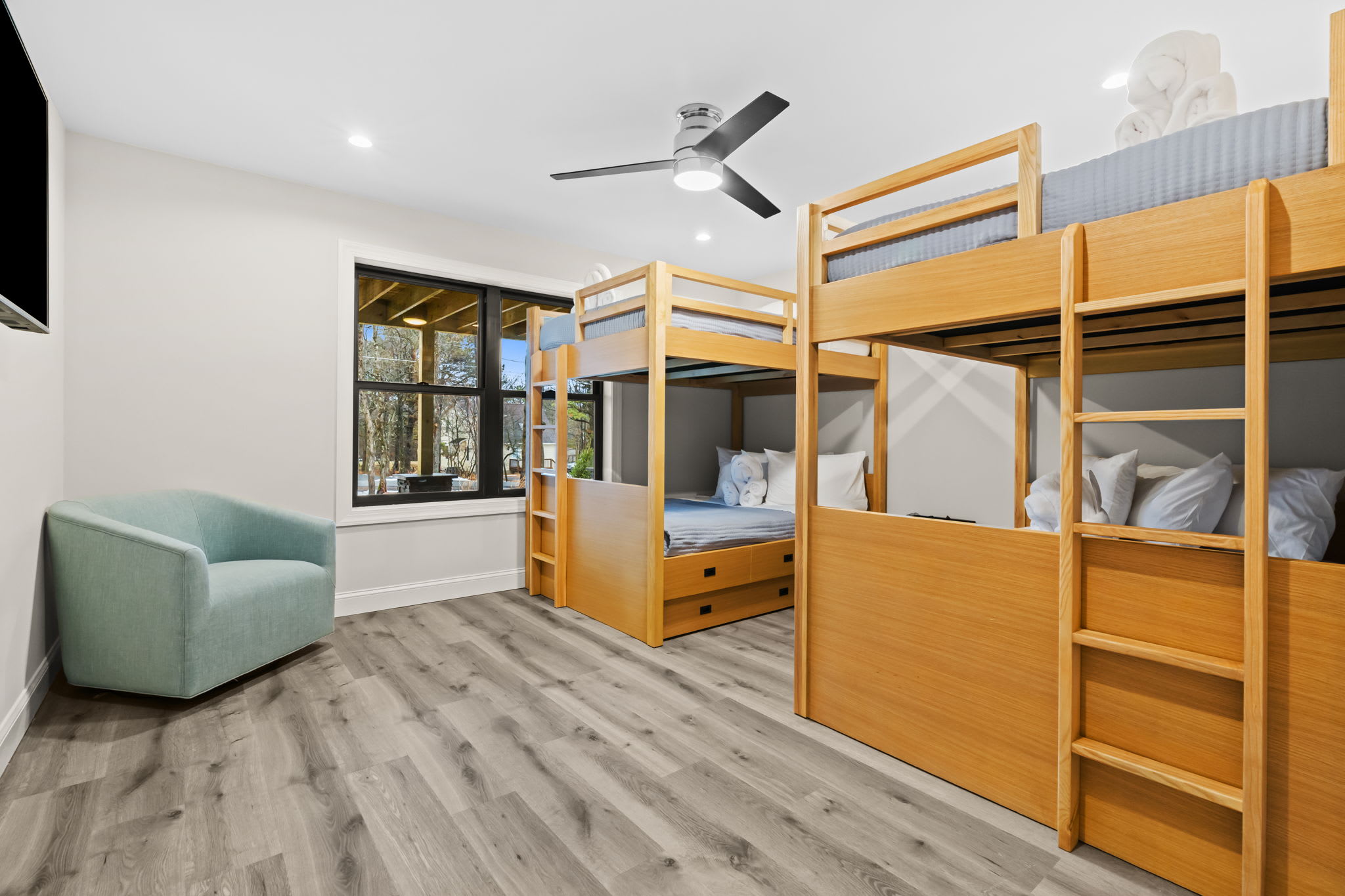 Cozy wooden bunks and a comfy reading nook make this room a hit with guests