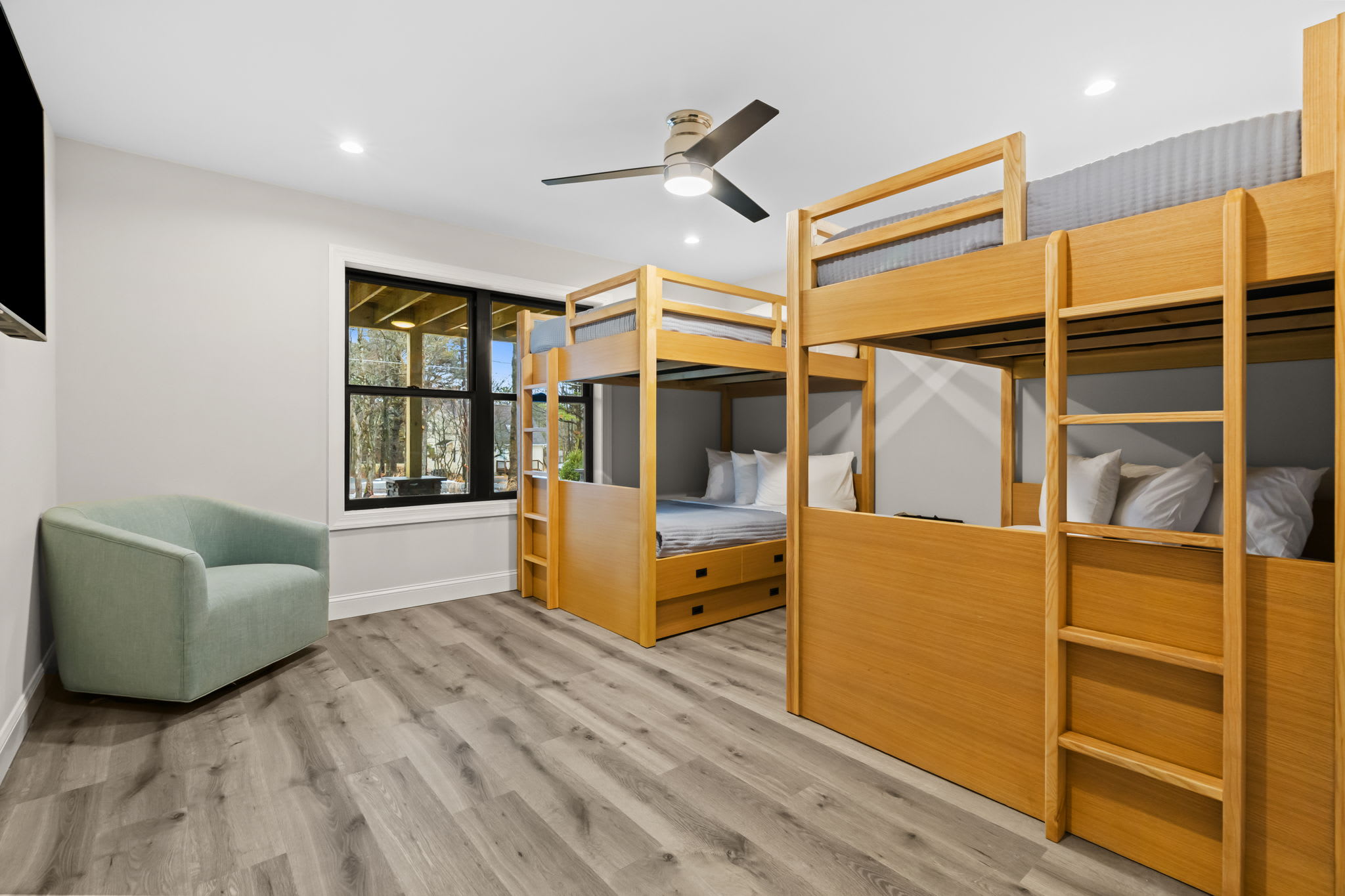 The fun bunk room features wooden bunks and a cozy seating area for hanging out