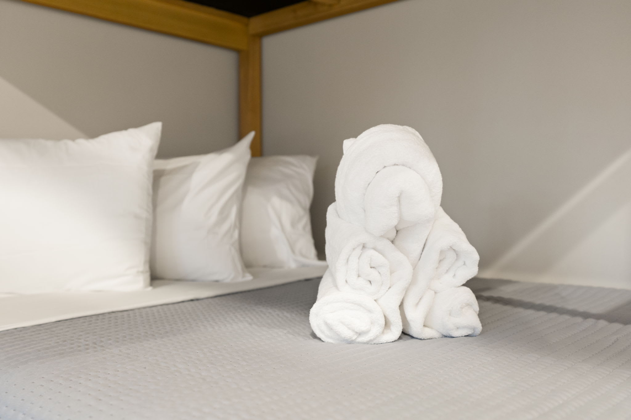 Fresh towels and crisp white linens welcome you to this peaceful bedroom
