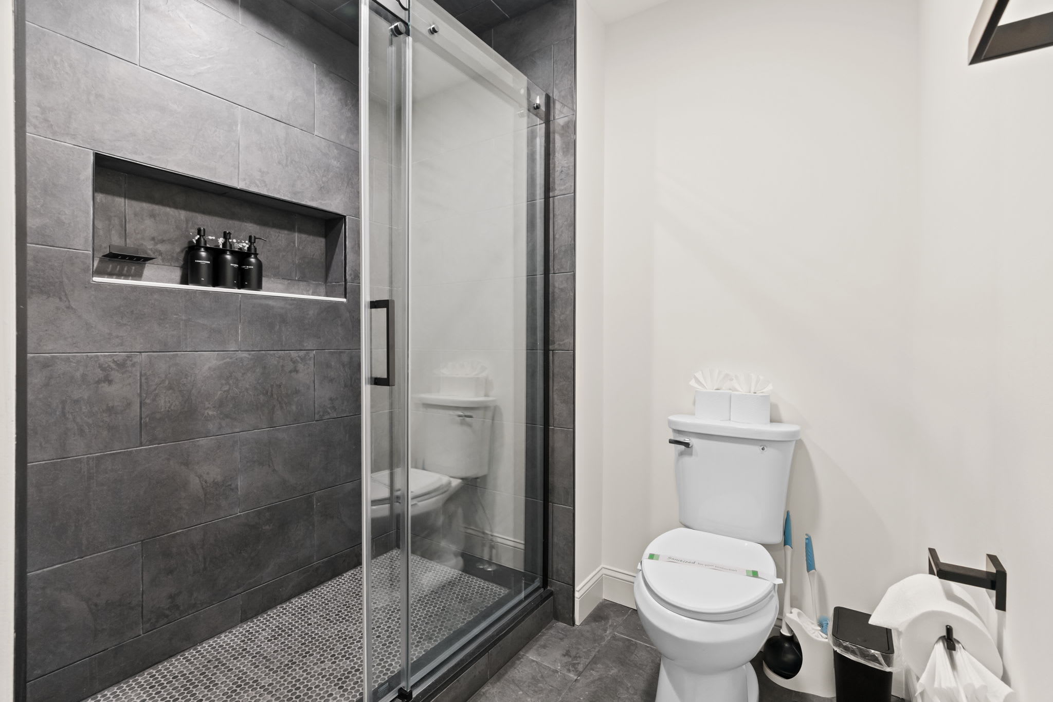 Modern bathroom with tile-accented walk-in shower and clean contemporary finishes