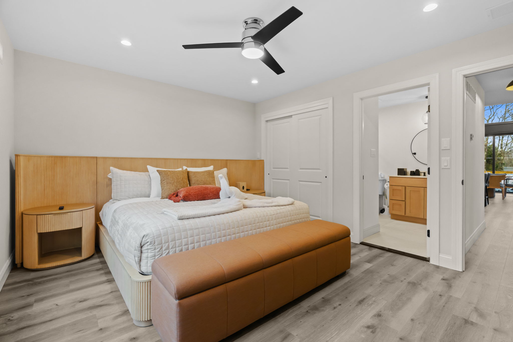 Find comfort in this sunny bedroom with golden bedding and natural wood furnishings