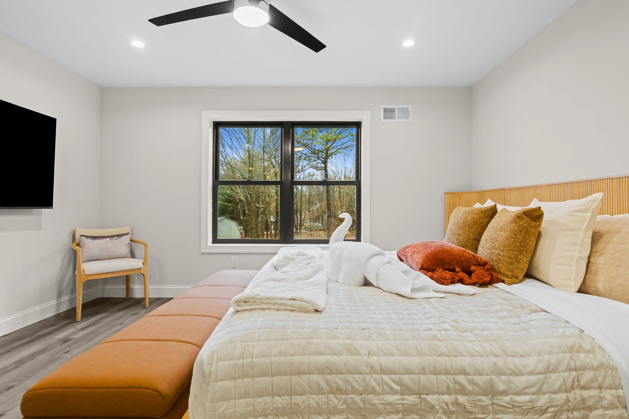 Colorful accent pillows add a pop of personality to this comfortable bedroom