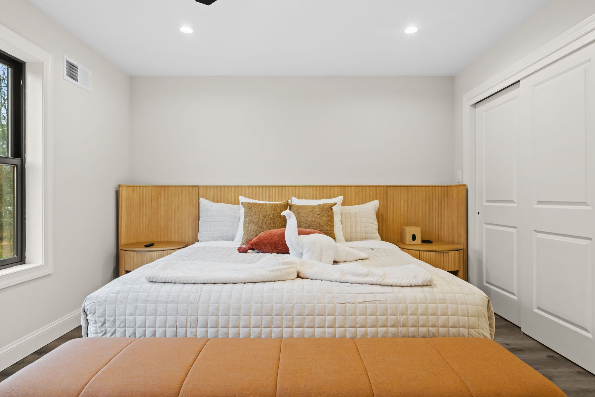 Snuggle into crisp white linens and enjoy the warm wood accents in this restful bedroom