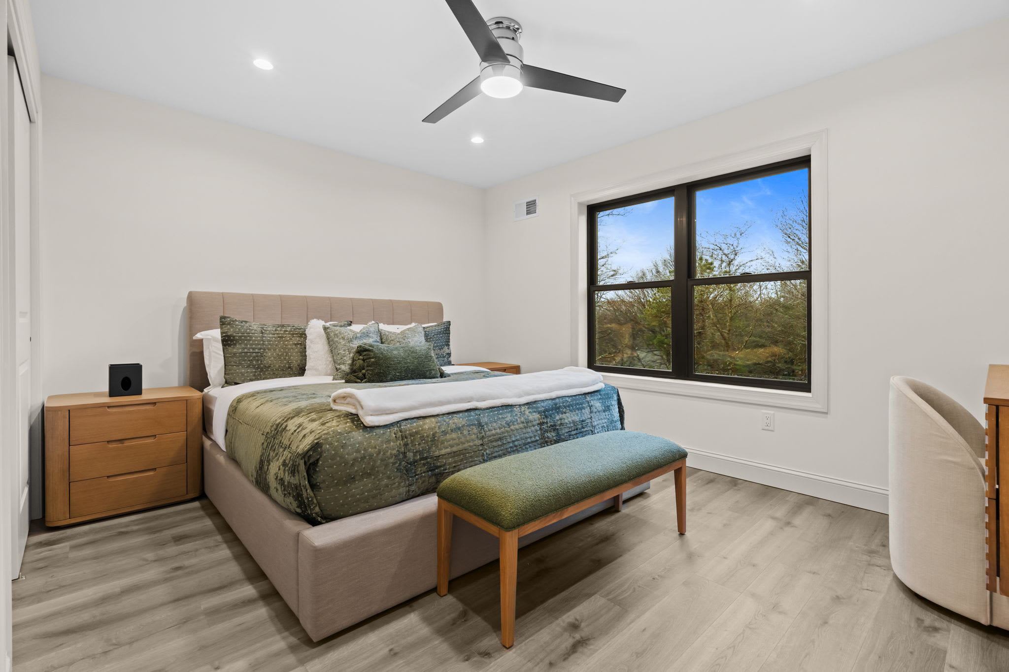 Wake up to peaceful treetop views in this bright and airy bedroom