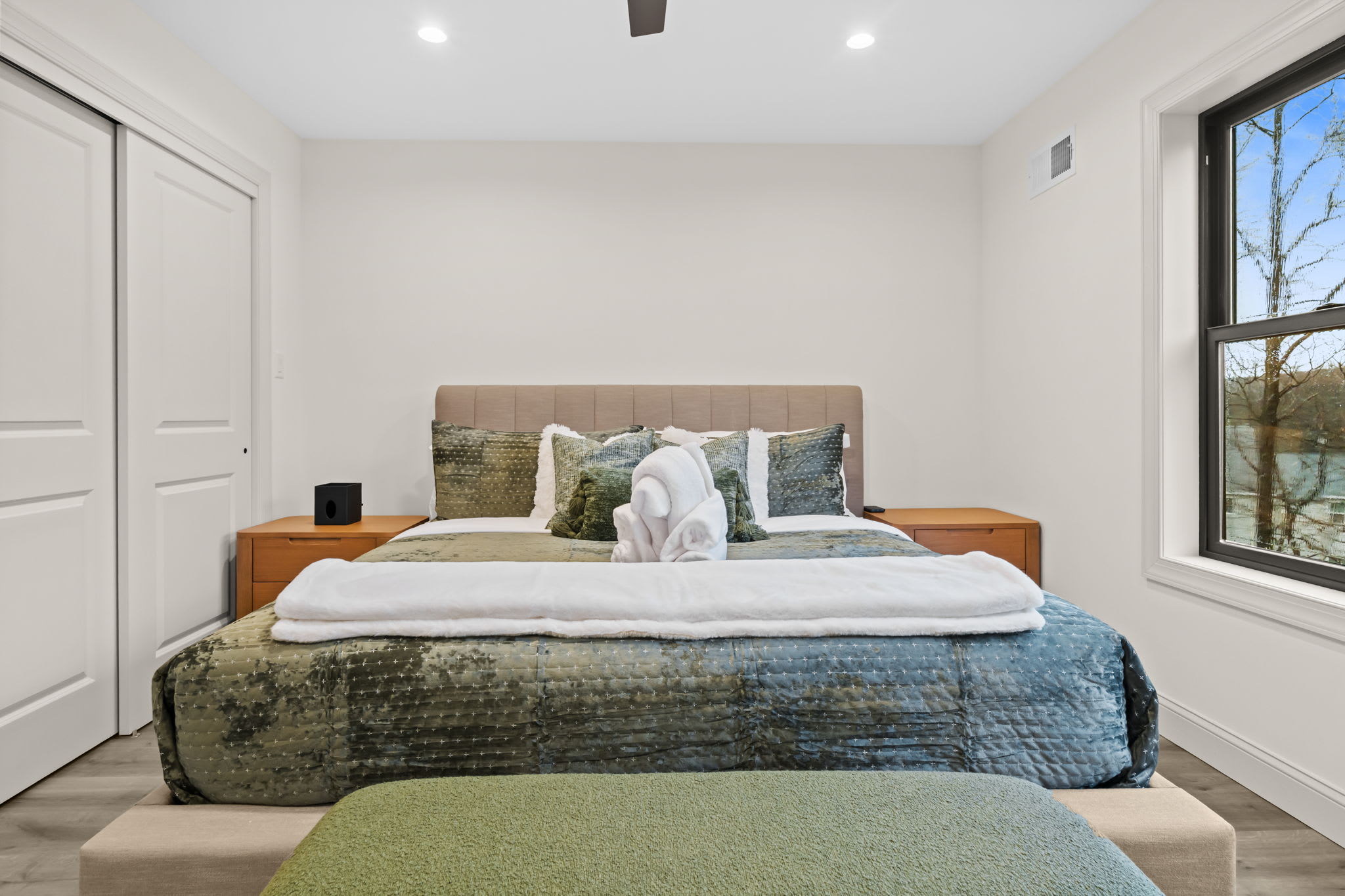 Each bedroom features a comfy bed, closet space, and views of the surrounding forest