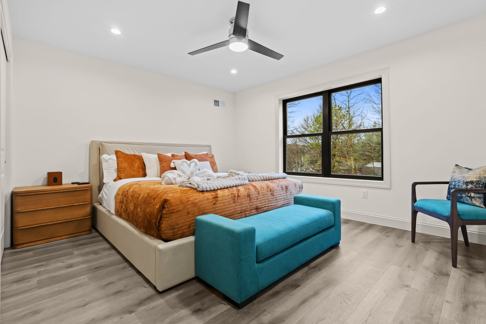 Bright and cheerful bedroom with colorful bedding and cozy seating nook