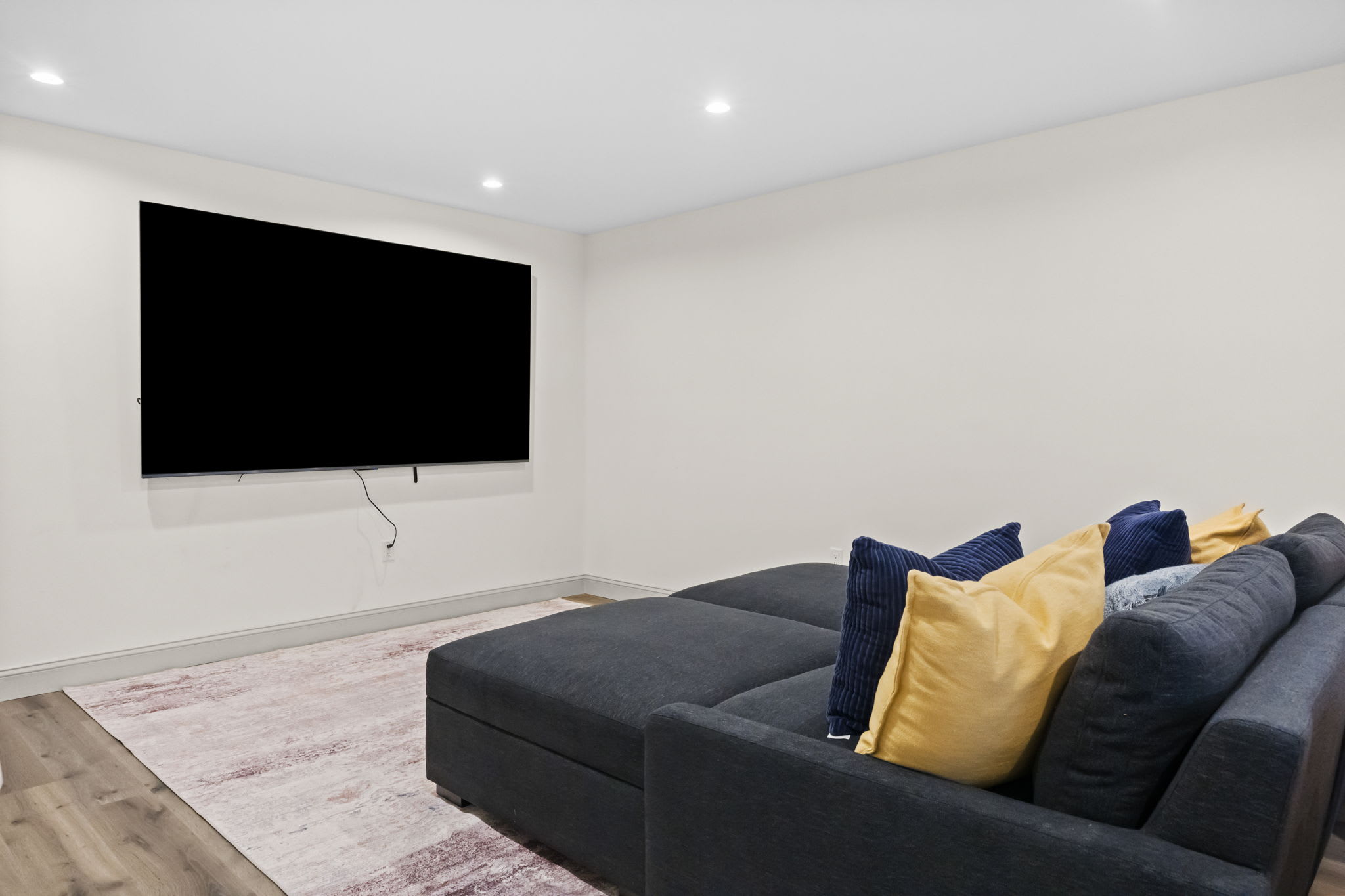 Queue up movie night in the lower level TV room with a big screen and comfy seating