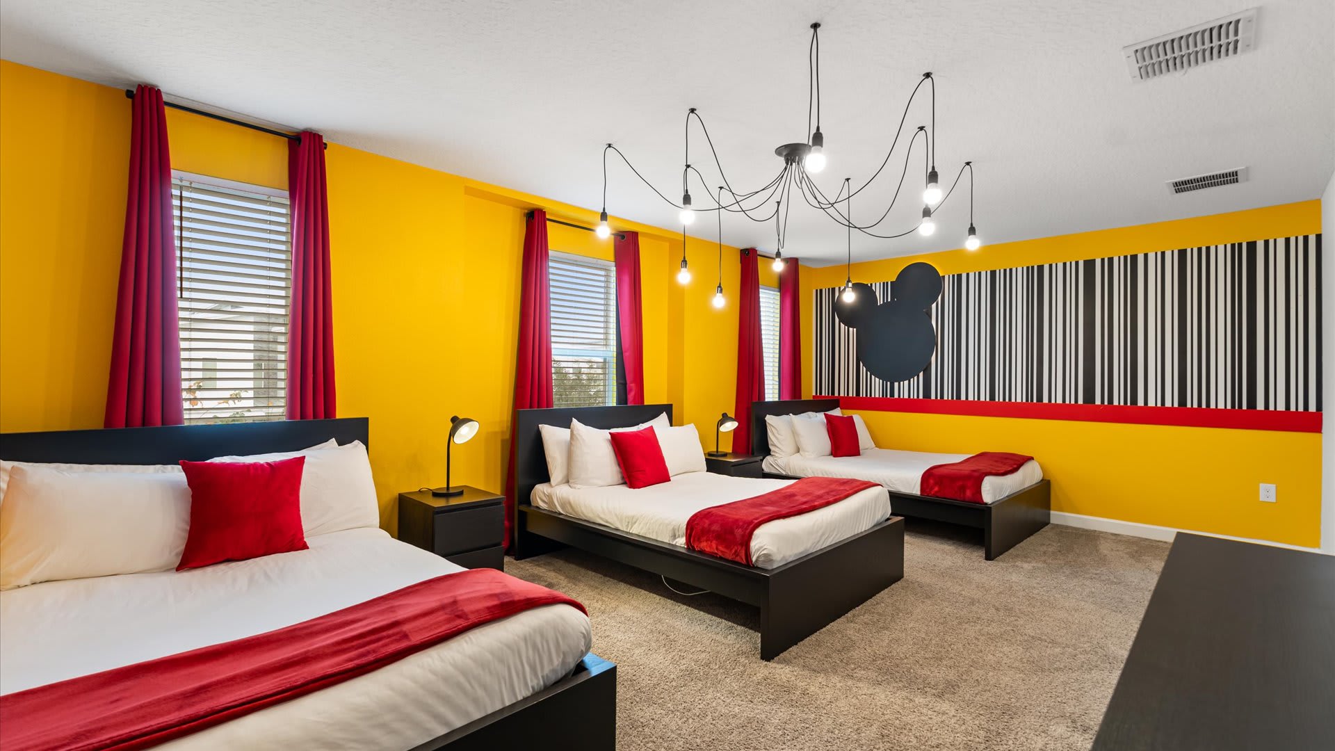 Mickey Mouse-themed bedroom with 3 double beds and smart TV