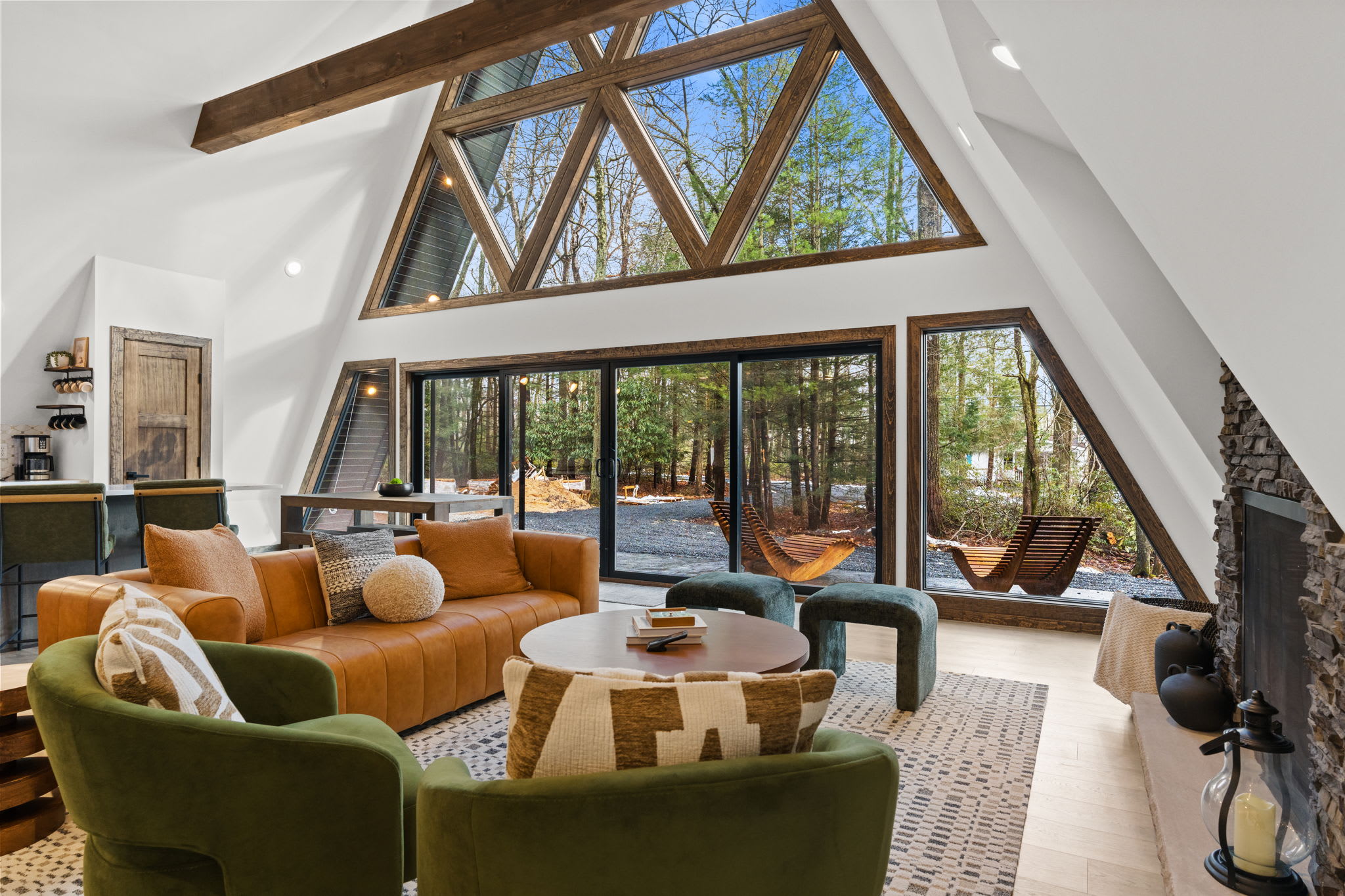 Cozy up by the fire with plush seating and sweeping woodland views through the glass