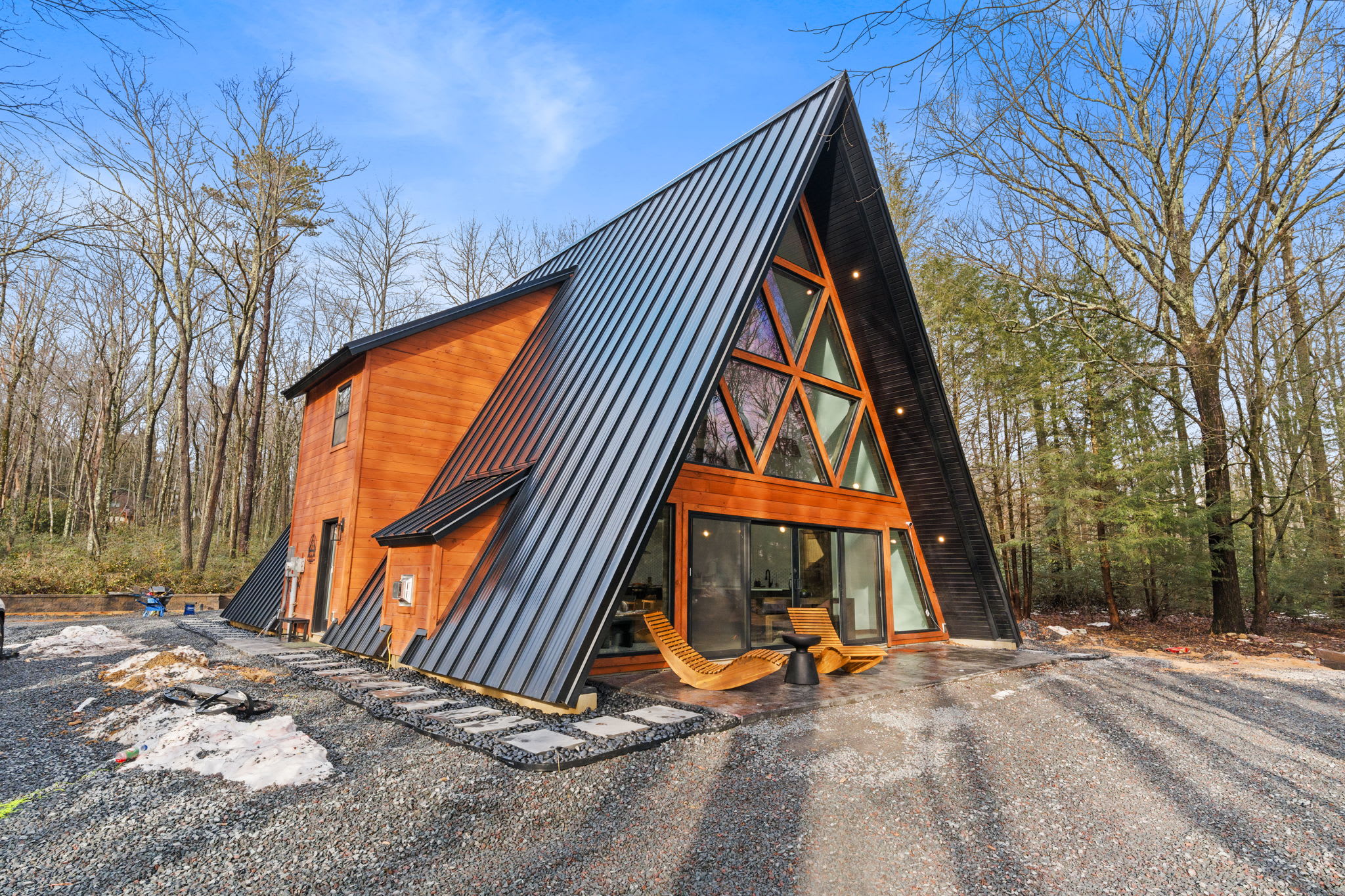 Arrive to this stunning A-frame cabin with its iconic glass facade and covered porch