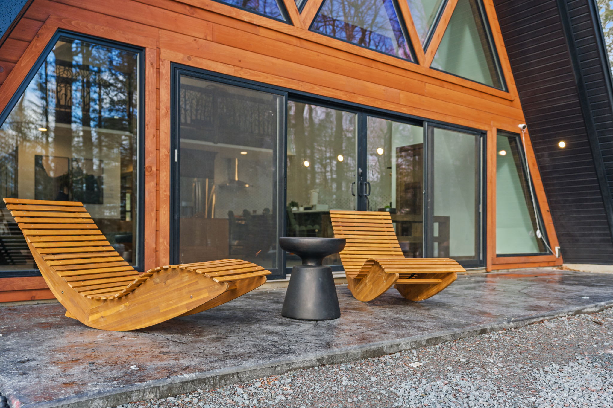 Relax on the covered porch with wooden loungers as day turns to dusk