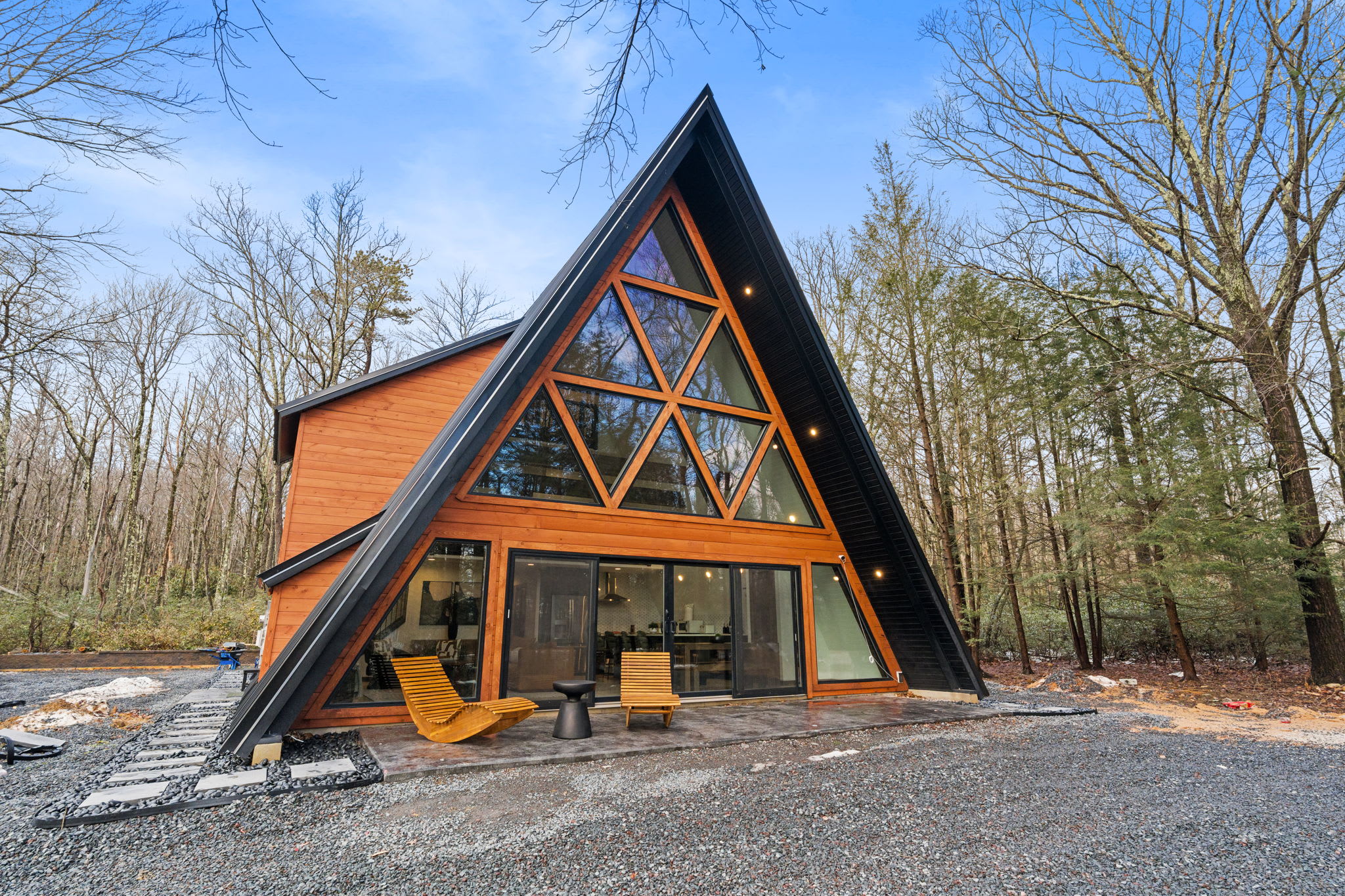 Fall foliage frames this iconic A-frame exterior with its striking glass facade