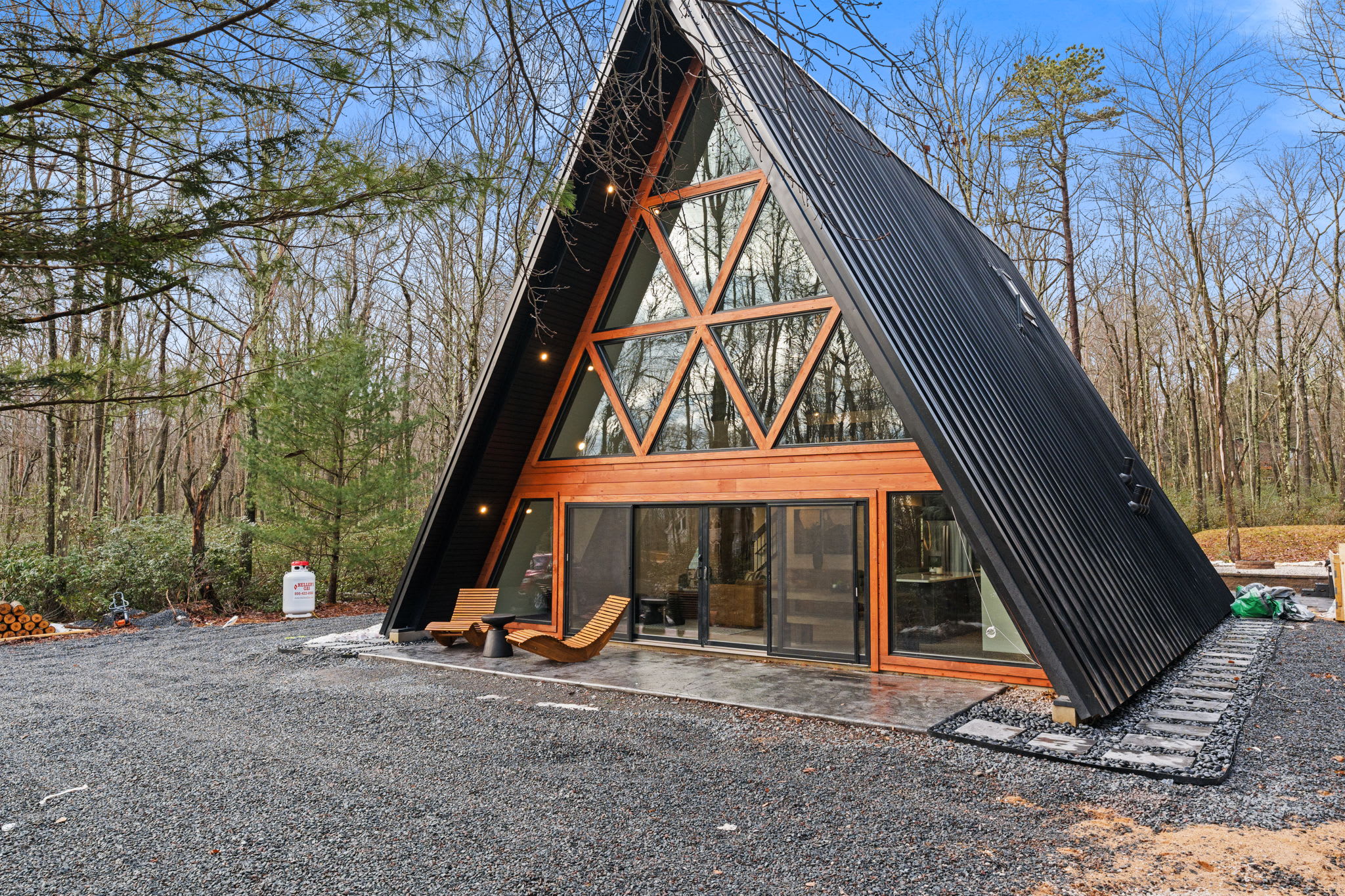 Take in the A-frame architecture from every angle surrounded by forest