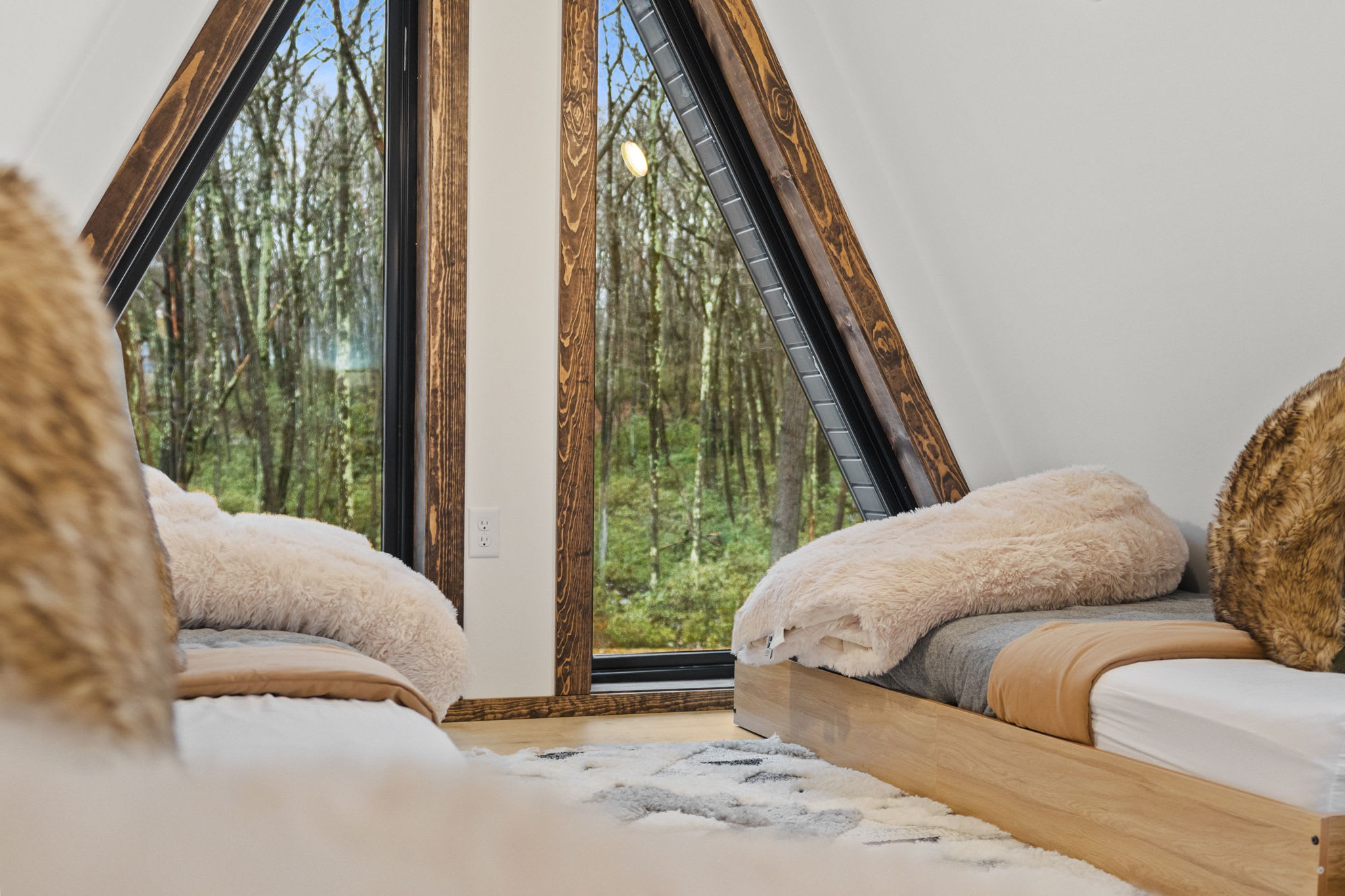 Nestle into plush throws and gaze out at the forest through the A-frame peak