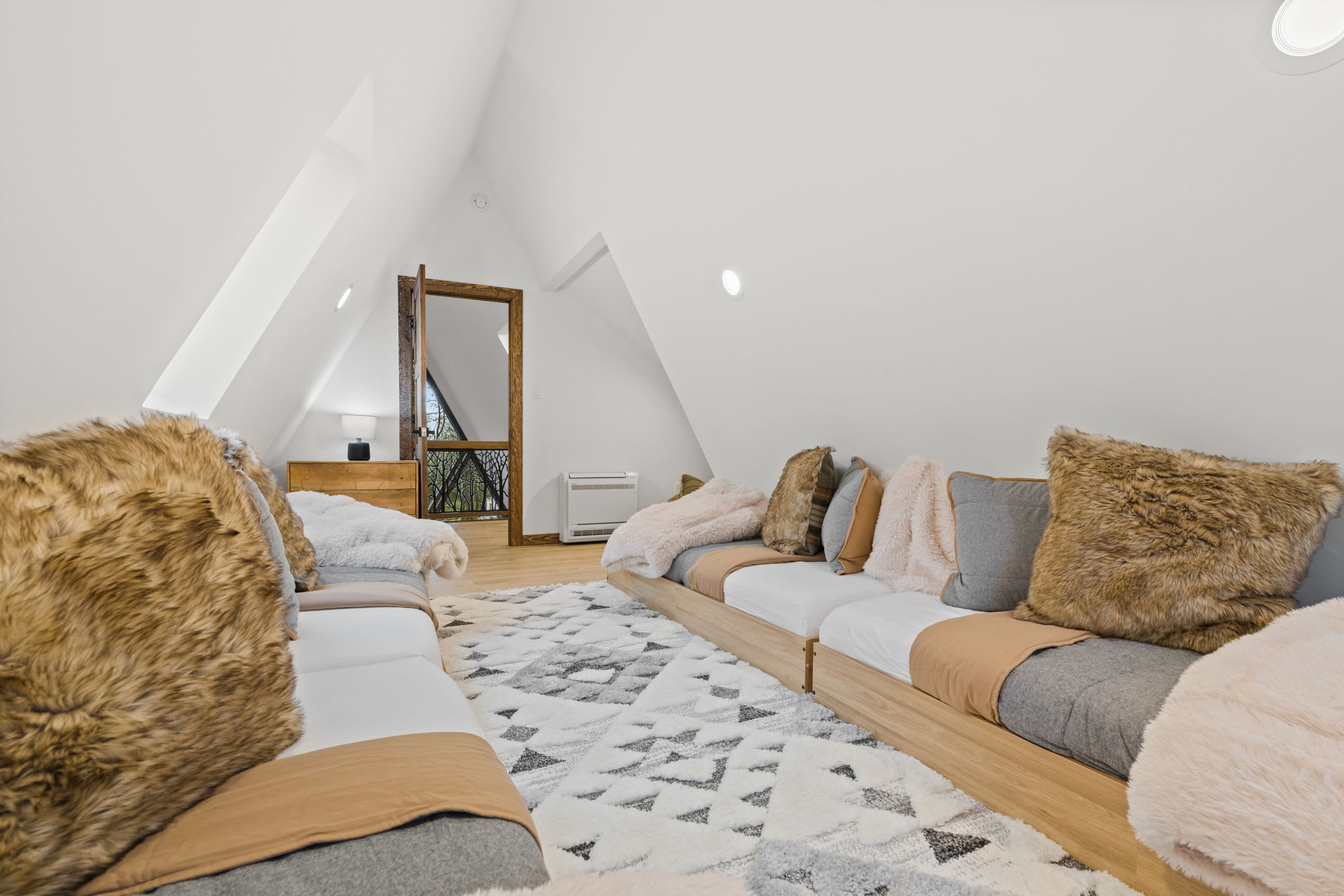 Wake up surrounded by treetops in the A-frame loft sleeping quarters