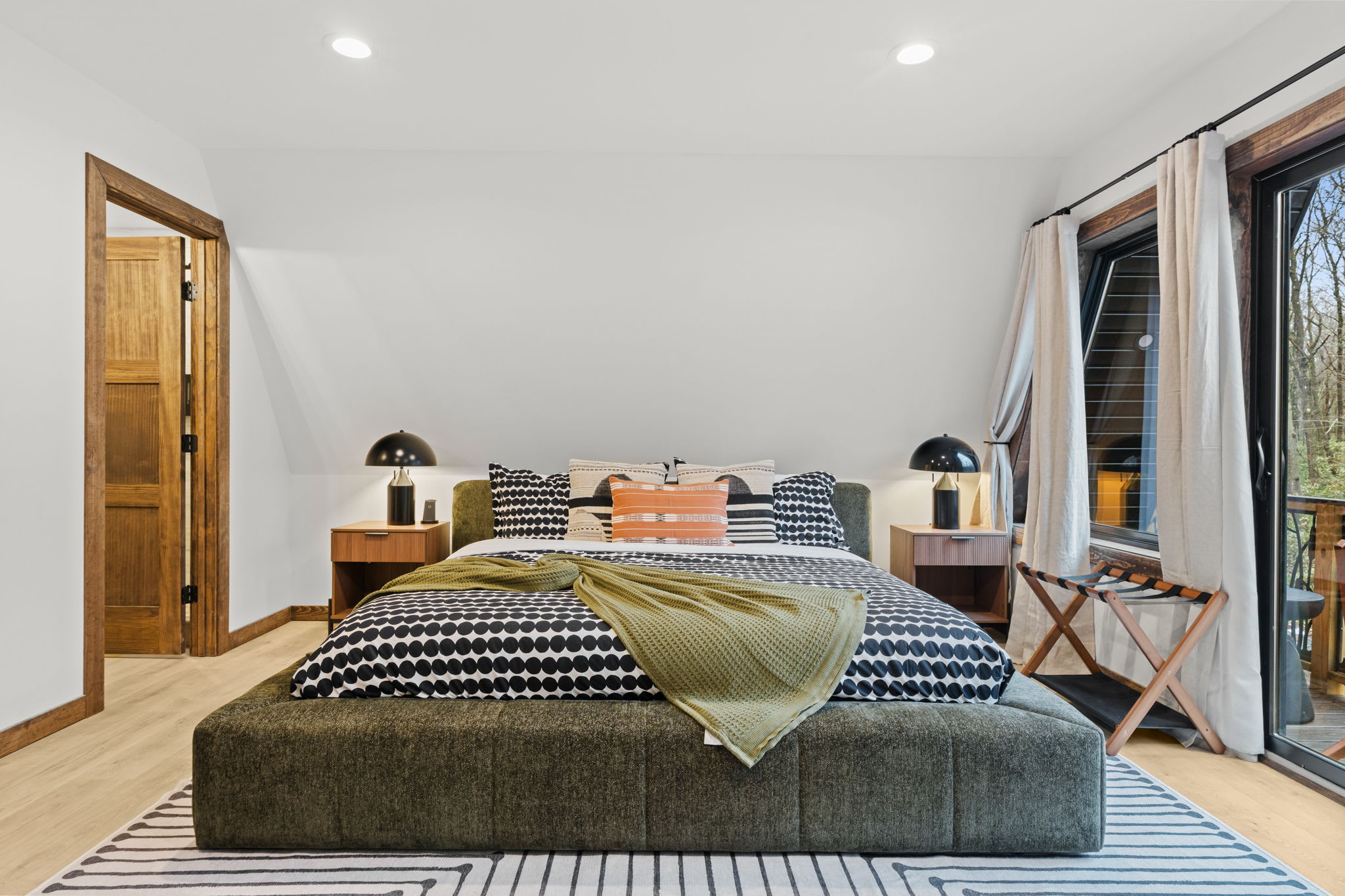 Unpack and settle into the serene third bedroom with its welcoming green bed