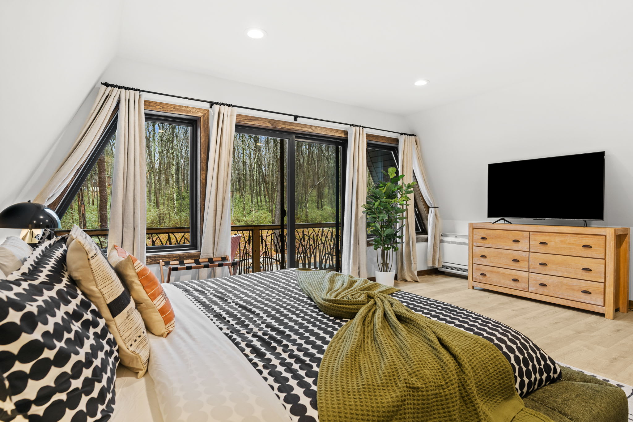 Sink into soft textures with cozy throws and pillows overlooking the forest