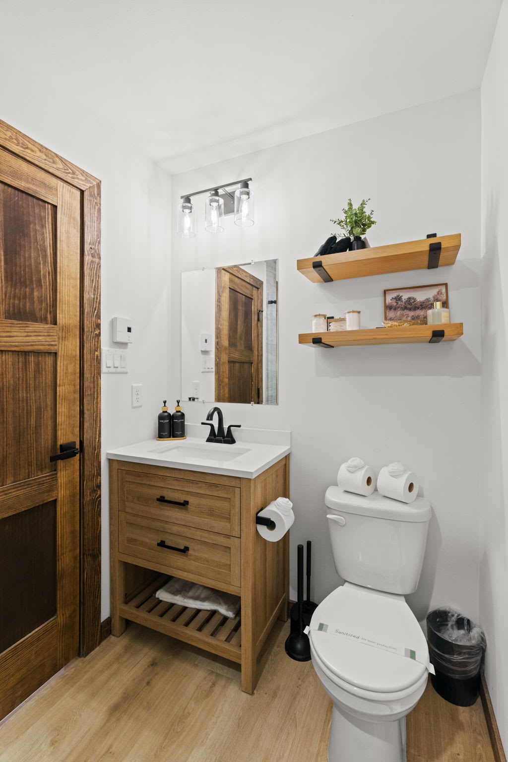Second bathroom offers a clean, modern space with natural wood accents