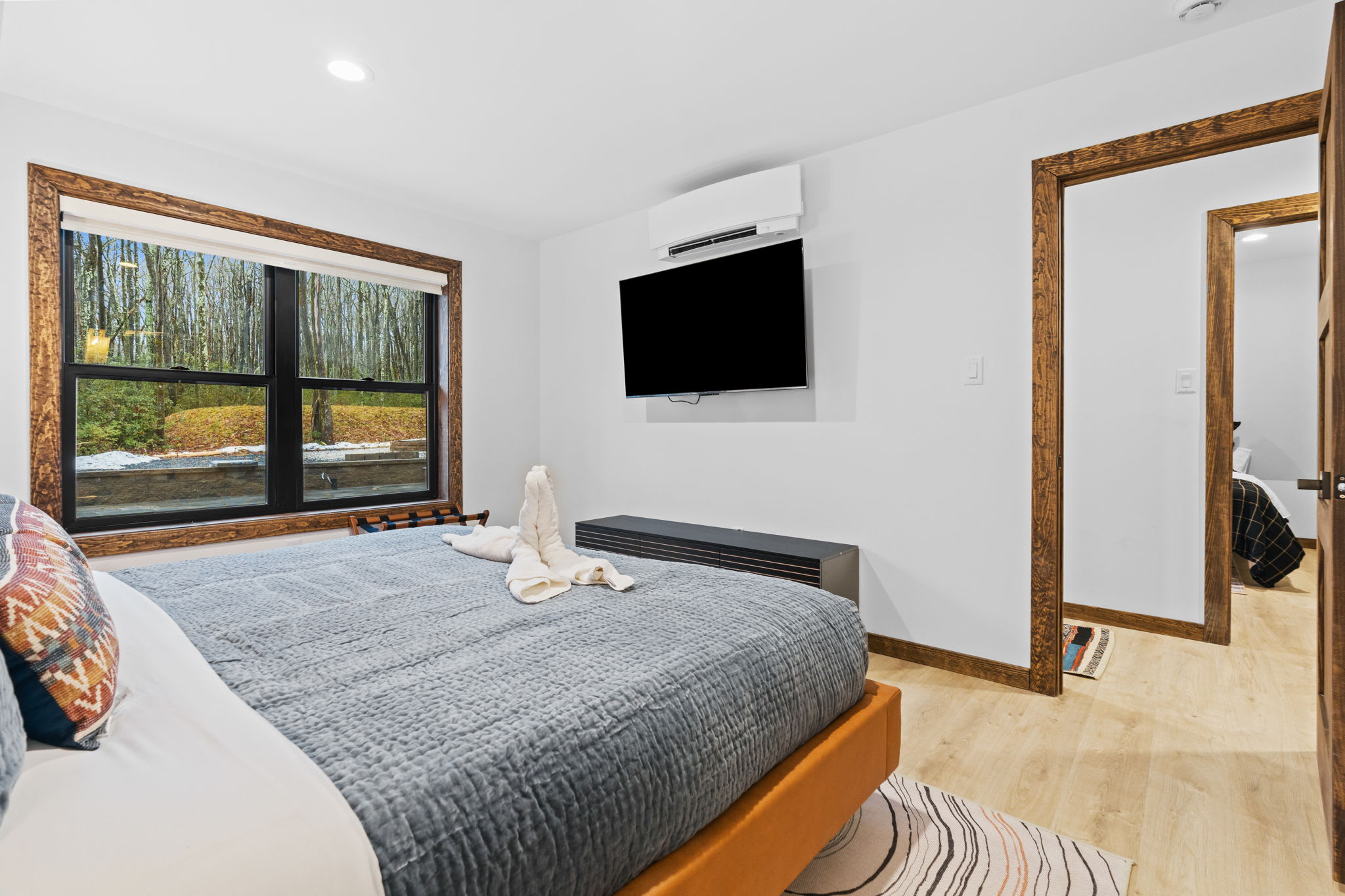 Sink into the king bed in the second bedroom with a towel art welcome