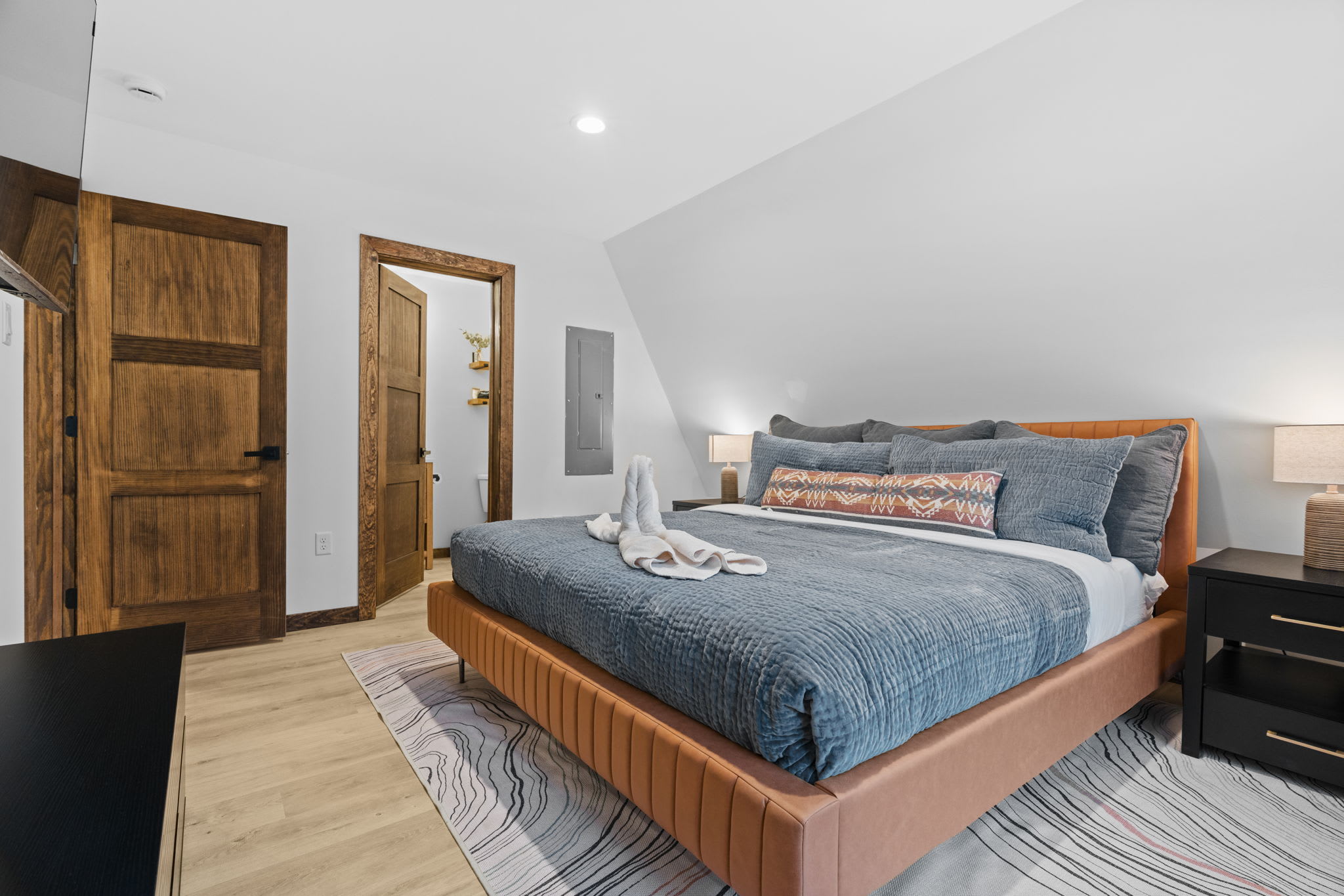 Rest easy in the second bedroom surrounded by serene winter forest views