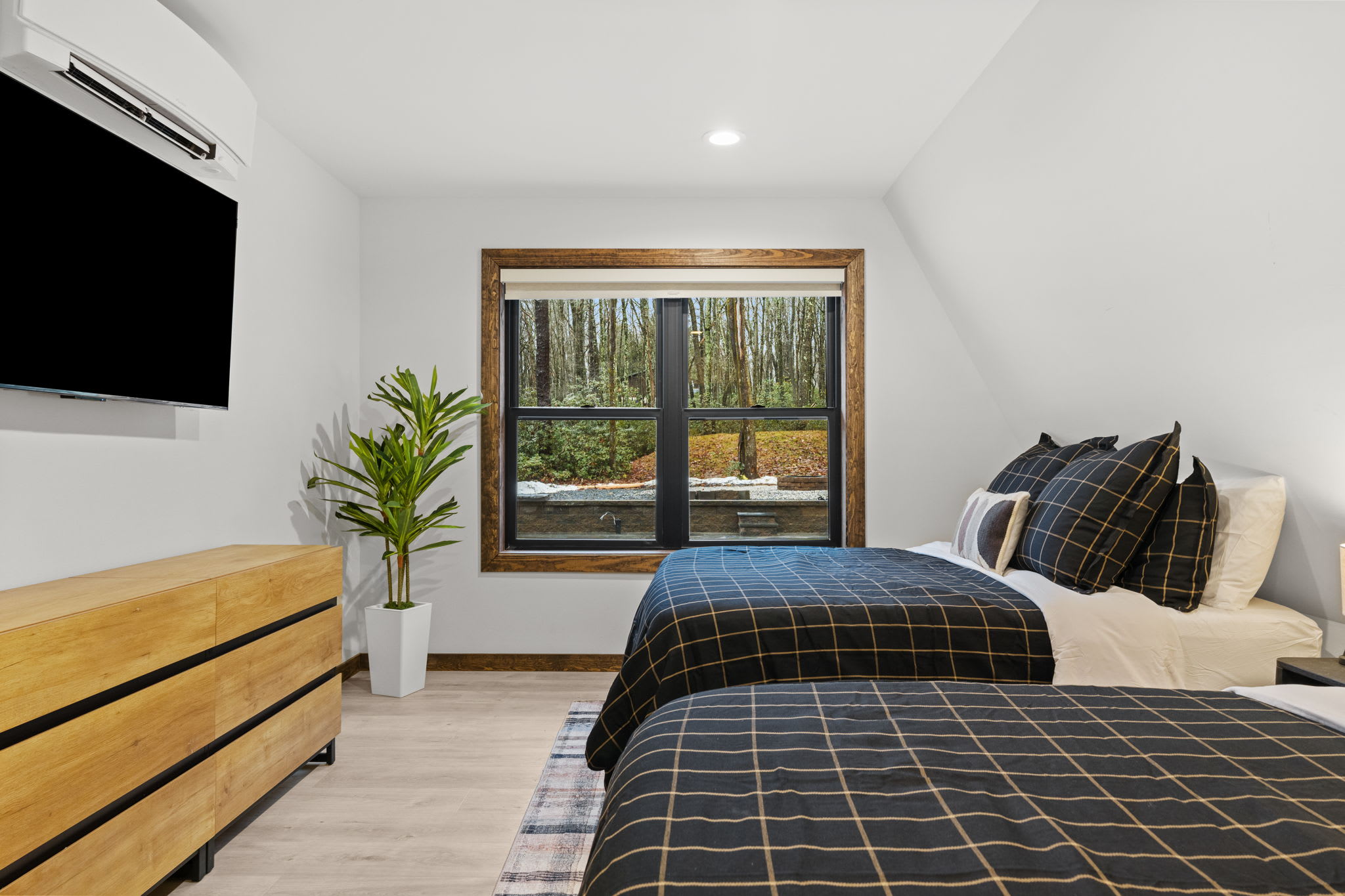 Unwind after a day of adventure with a TV and woodland views in the first bedroom