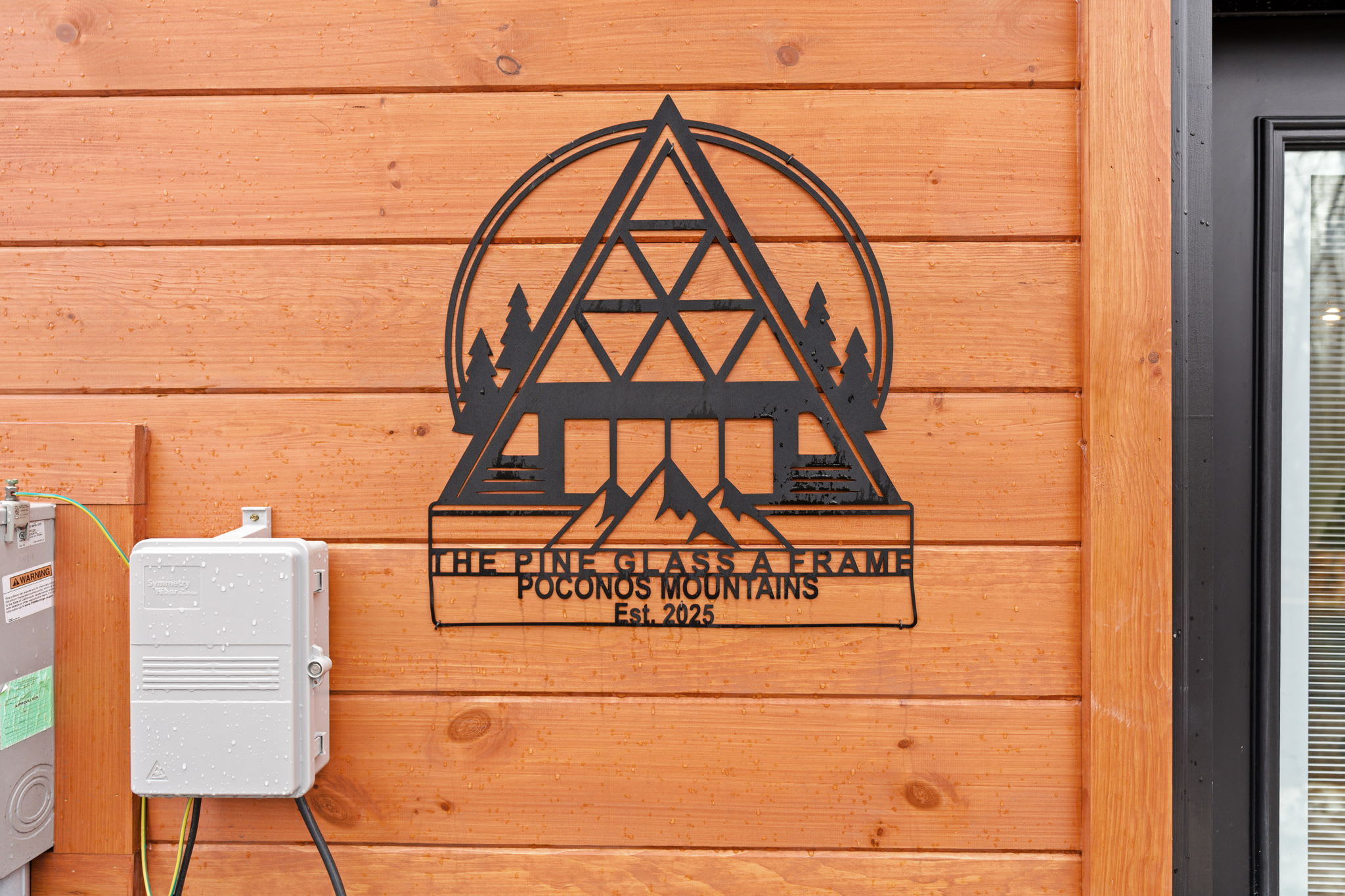 Custom cabin sign welcomes you to The Pine Glass A-Frame mountain escape