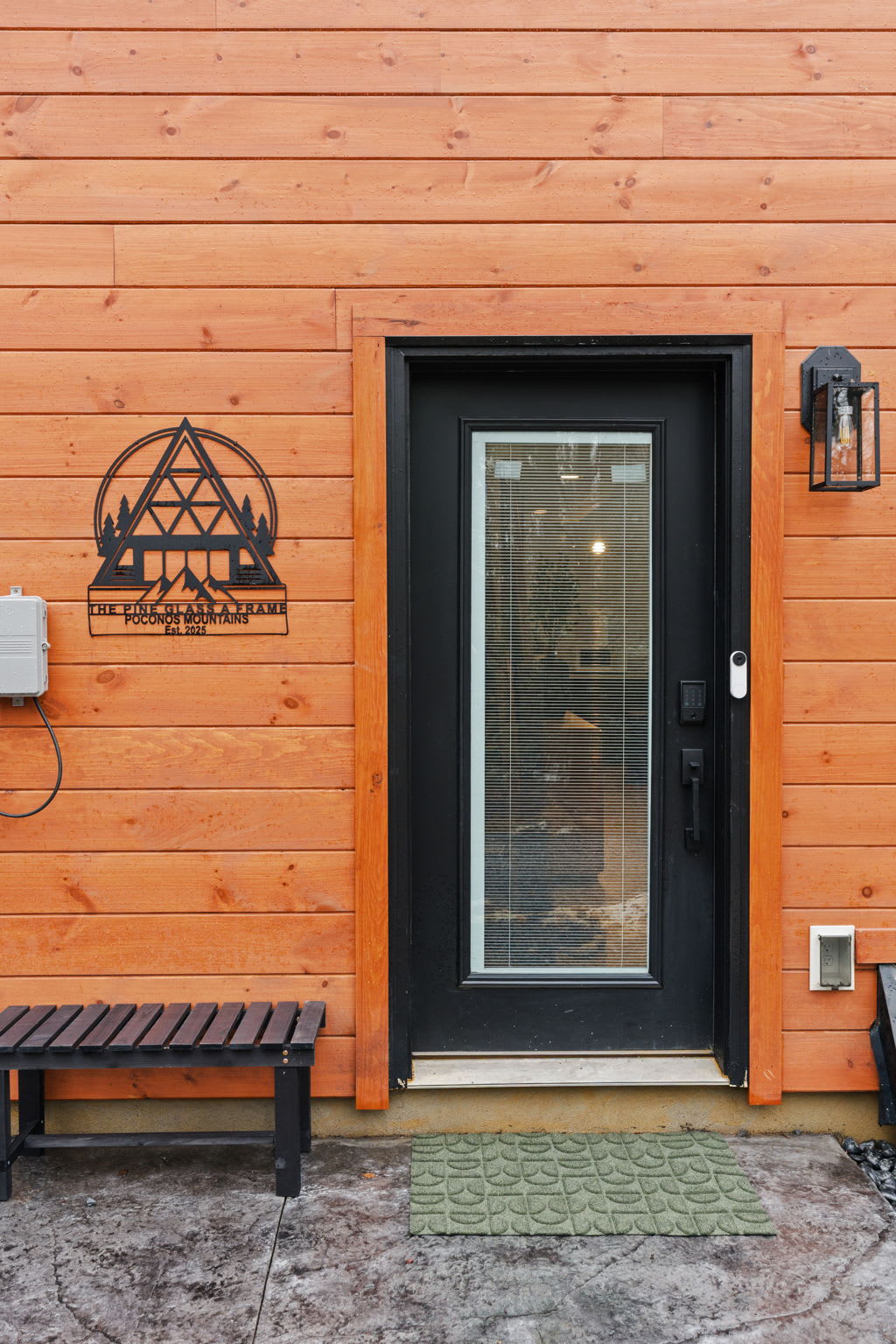 Welcoming side entrance with glass-paned door and warm cedar siding details