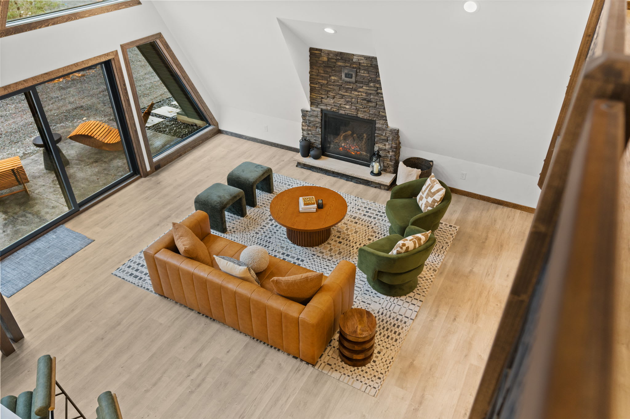 Look down from the loft onto the inviting living and dining spaces below