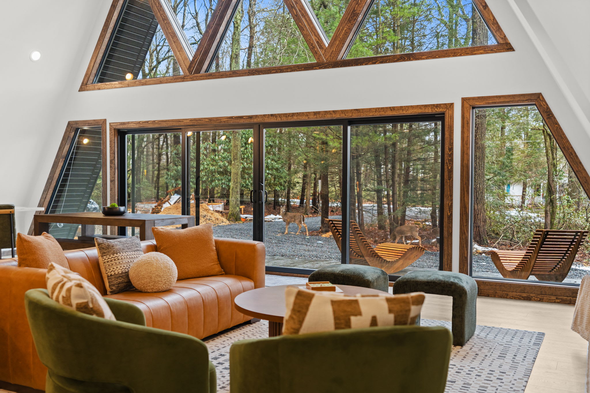 Unwind in the cozy living room with a stunning wall of A-frame windows.